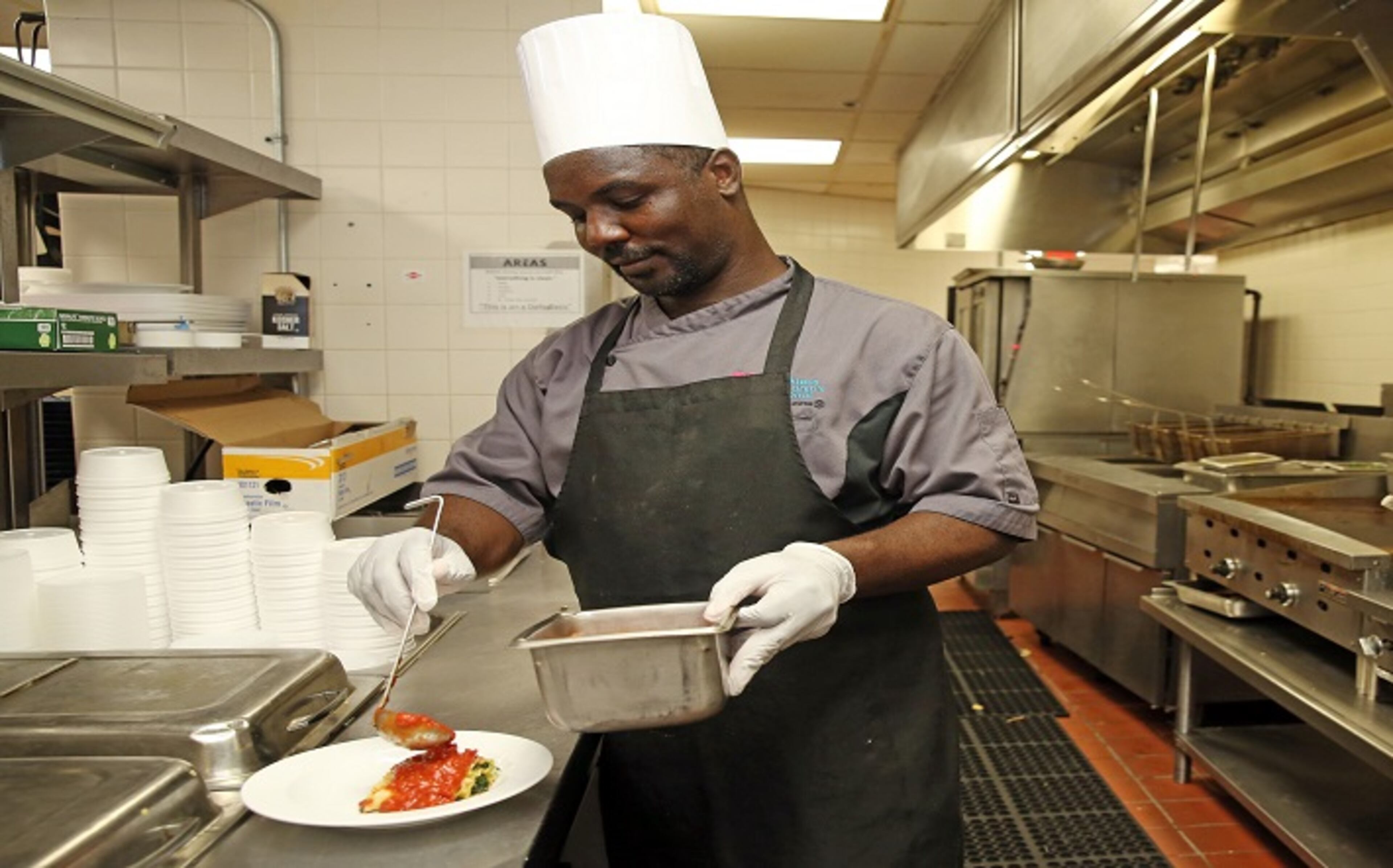 Chef Tony Randolph prepares a veggie lasagna roll, one of the healthy choices on the menu at Jack Nicklaus Children's Hospital, where kids can order a meal at any time and have it made and delivered fresh within 30 minutes. (Emily Michot/Miami Herlad/TNS)