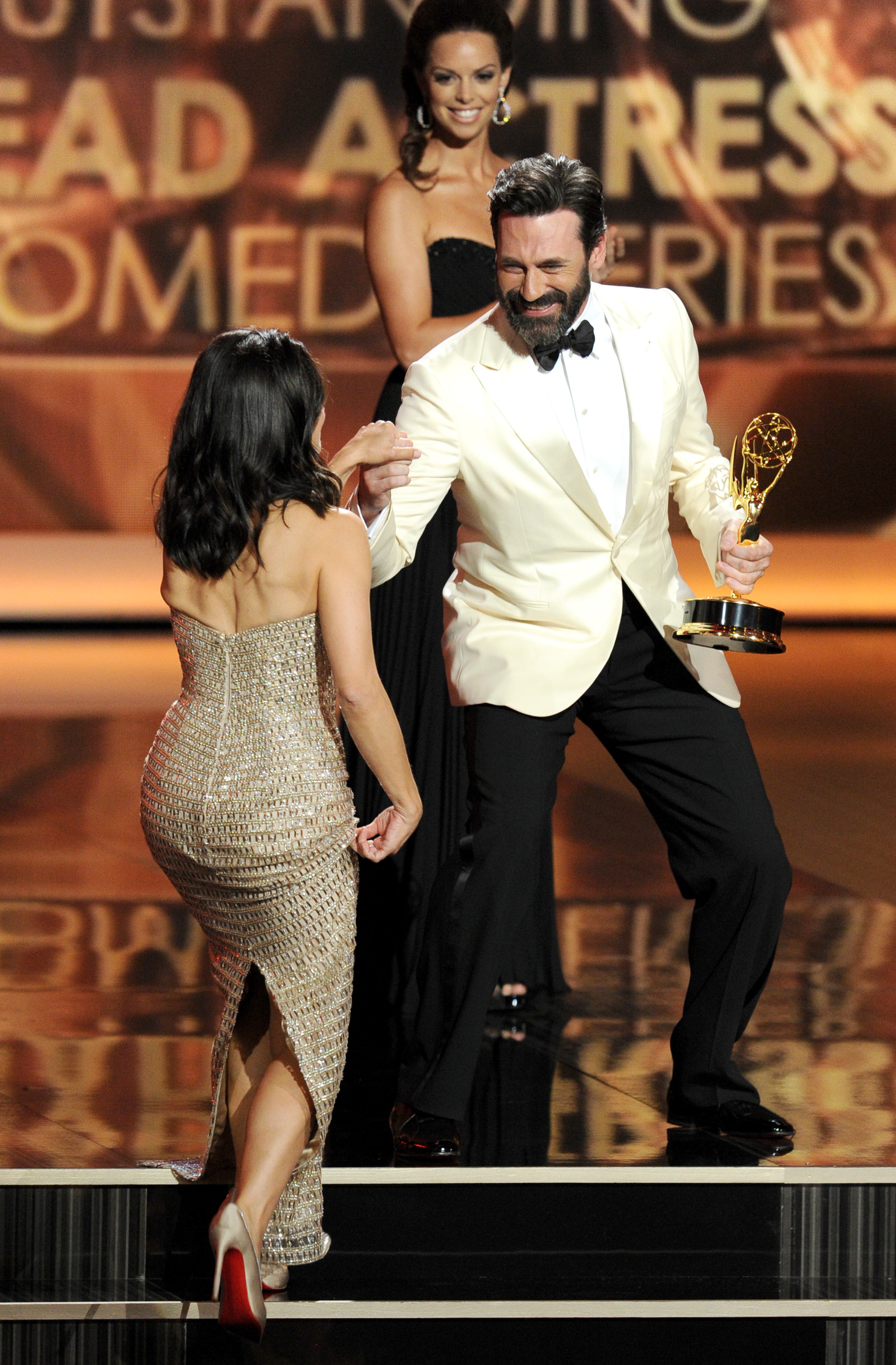 LOS ANGELES, CA - SEPTEMBER 22: Winner for Best Lead Actress in a Comedy Series, Julia Louis-Dreyfus receives her award from actor Jon Hamm onstage during the 65th Annual Primetime Emmy Awards held at Nokia Theatre L.A. Live on September 22, 2013 in Los Angeles, California. (Photo by Kevin Winter/Getty Images)