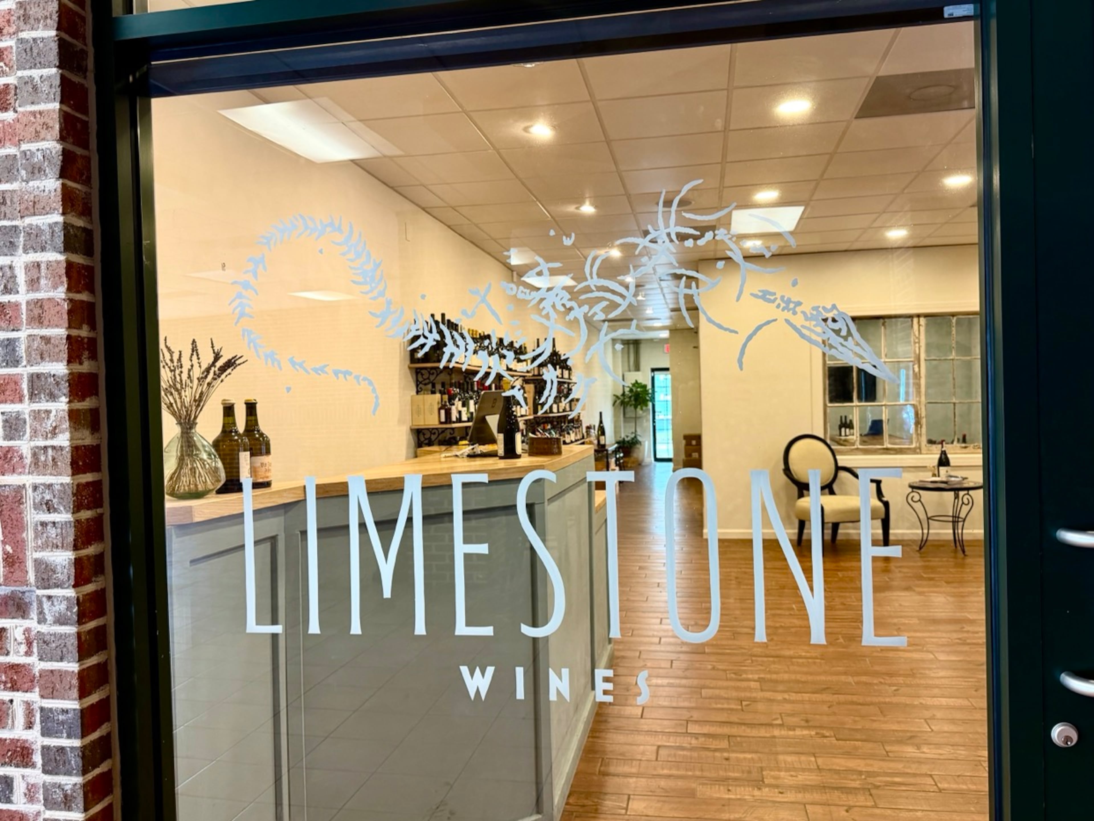 Limestone Wines is in a commercial plaza near the intersection of East Oglethorpe Avenue and Price Street in Savannah. The logo includes an image inspired by a dinosaur fossil found in a vineyard in the Jura region of France. (Bill Dawers for the AJC)