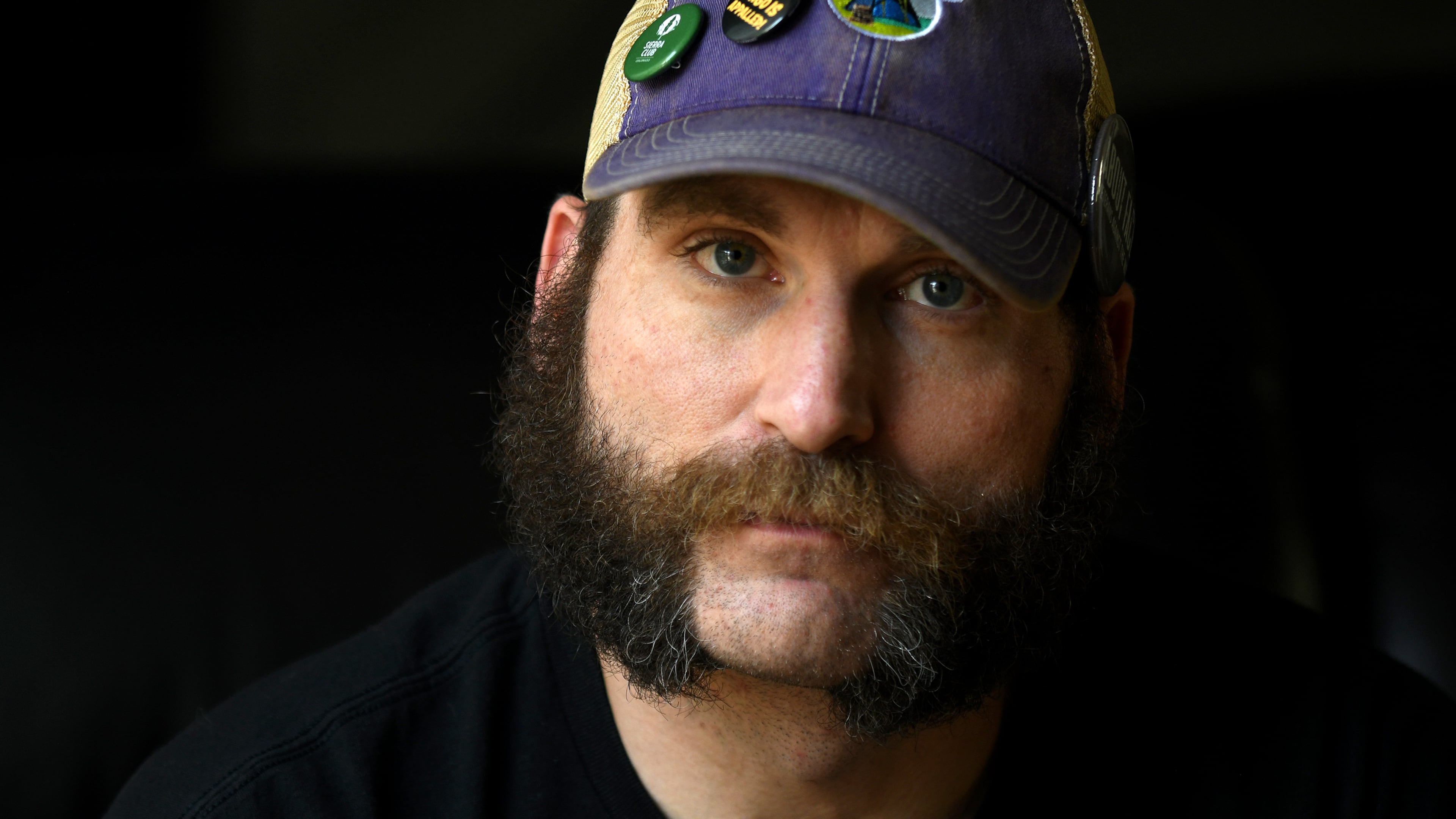 Joe Shearer, who was diagnosed with traumatic brain injuries from fighting in Iraq, poses for a portrait in his home in Colorado Springs, Colo., Wednesday, Aug. 5, 2026. (AP Photo/Thomas Peipert)