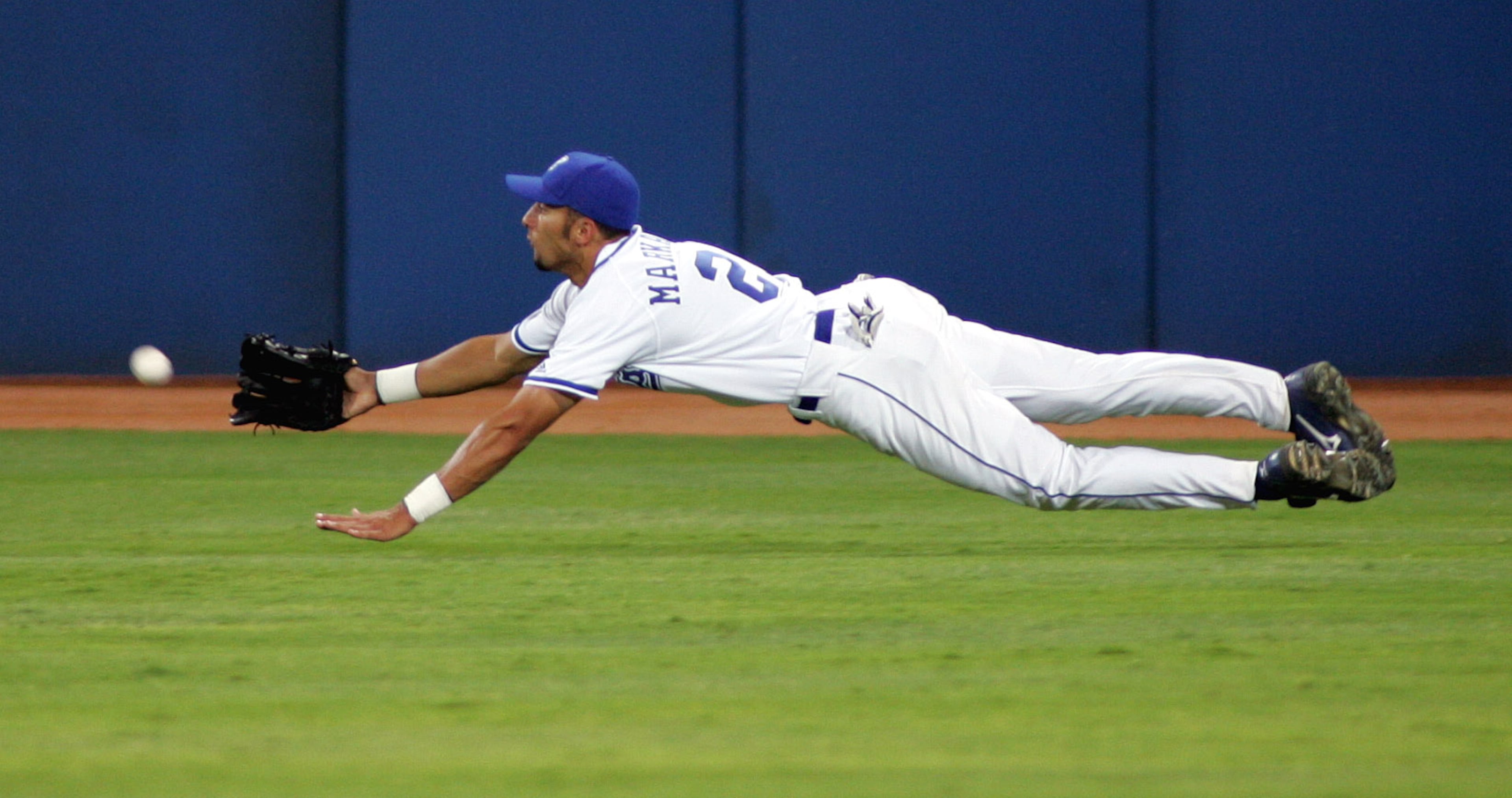 Greece right fielder Nicholas Markakis dives for hit by Netherlands' Eugene Kingsale during the sixth inning of their preliminary round game at the Olympic Baseball Center at the 2004 Olympic Games in Athens, Sunday, Aug. 15, 2004. (AP Photo/Eric Gay)