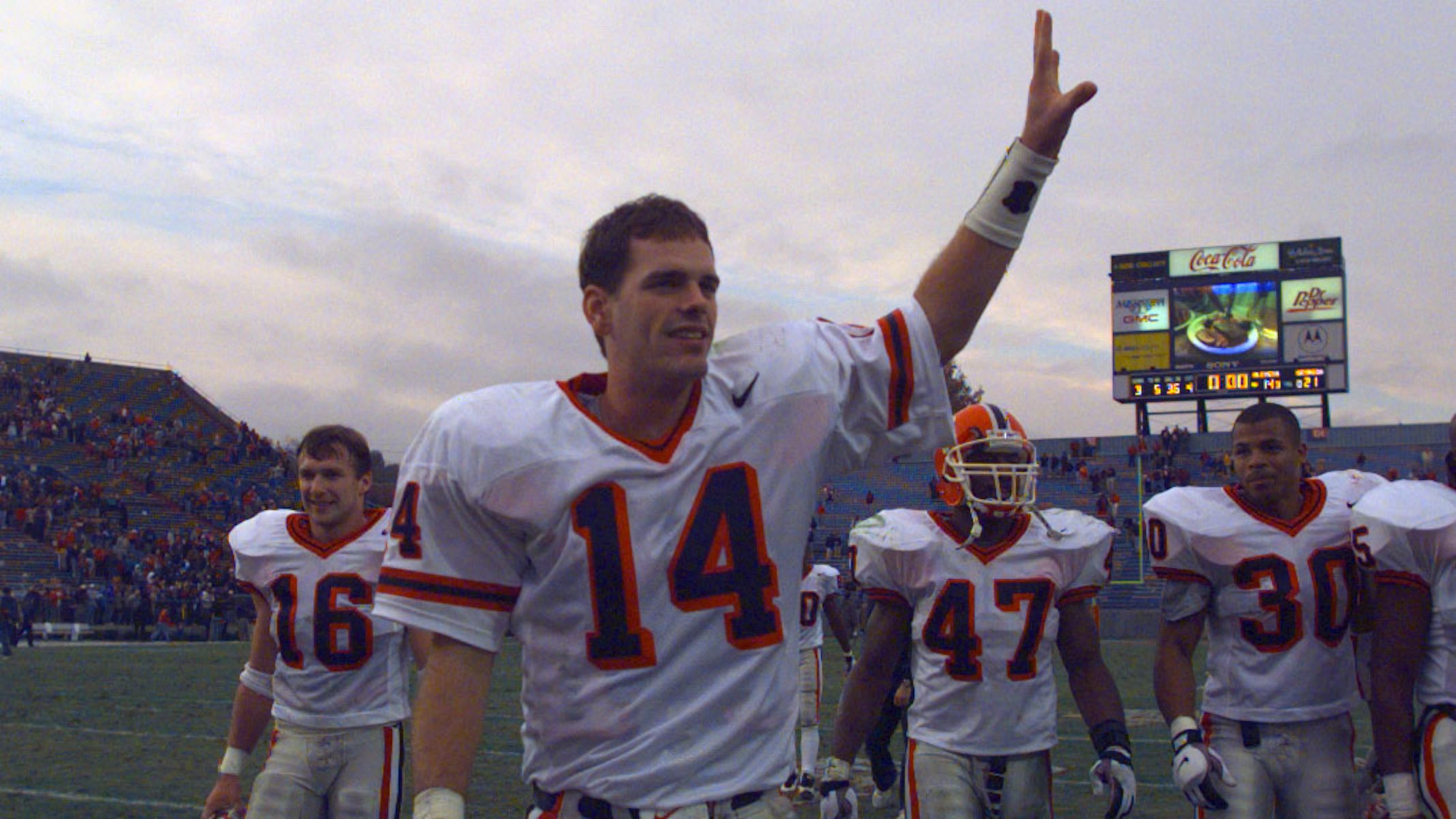 Georgia quarterback Mike Bobo waves as he walks off the field after beating Ole Miss in 1997. Current UGA coach Kirby Smart (16) walks behind him. (AJC File)