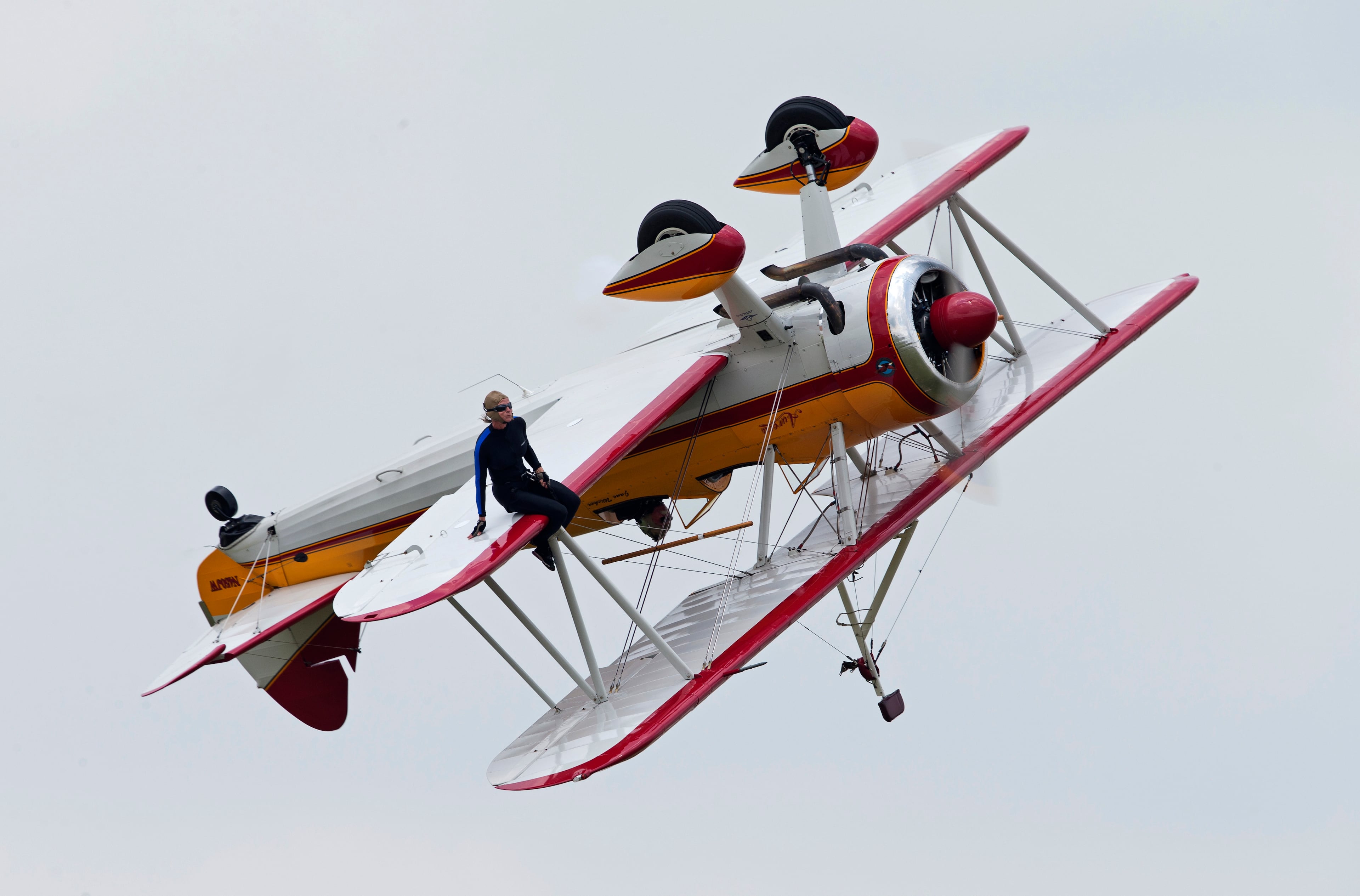 A wing walker performs at the Vectren Air Show just before crashing, Saturday, June 22, 2013, in Dayton, Ohio. The crash killed the pilot and the stunt walker instantly, authorities said. (