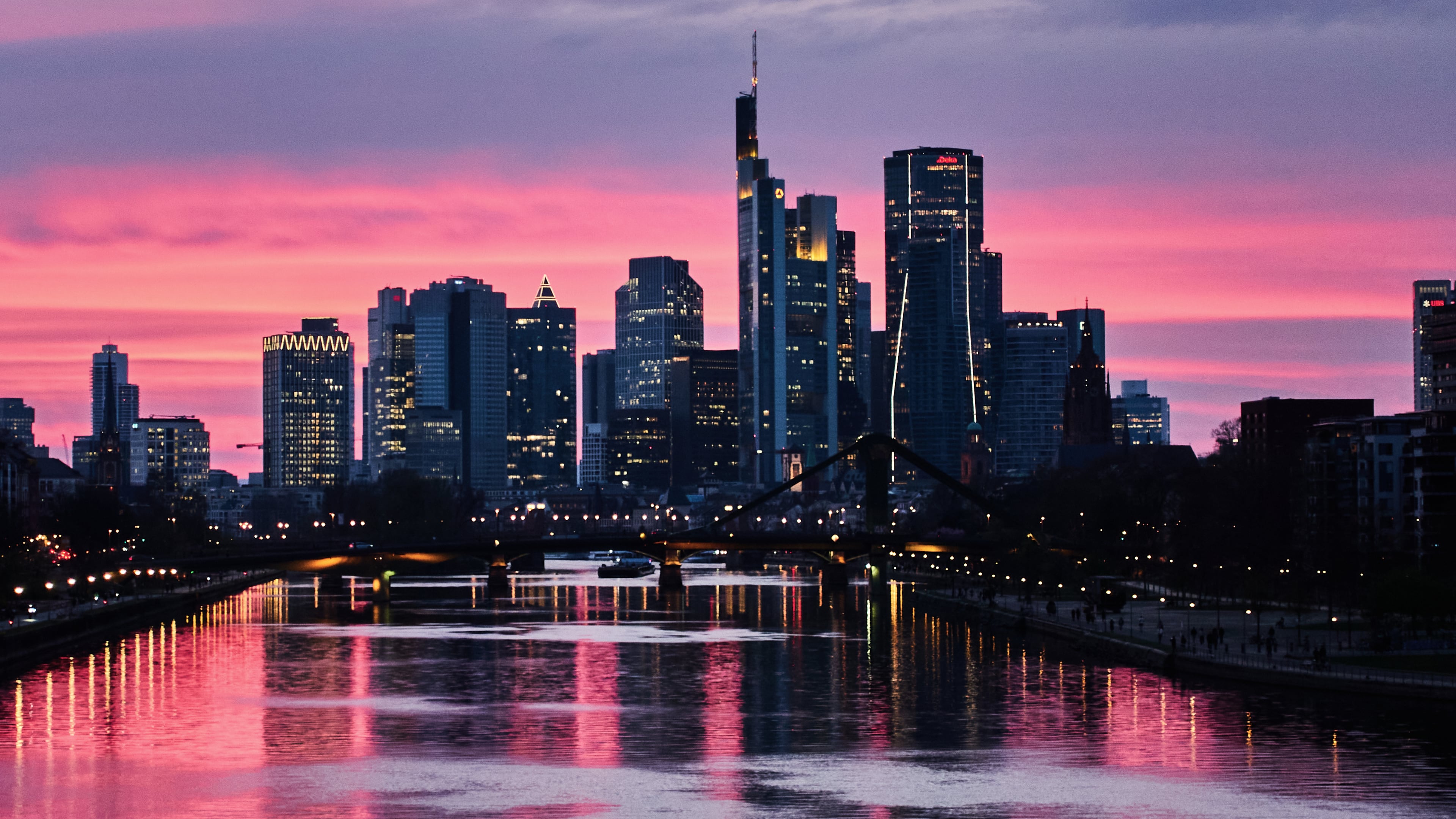 The sun has set behind the buildings of the banking district in Frankfurt, Germany, late Tuesday, March 24, 2026. (AP Photo/Michael Probst)