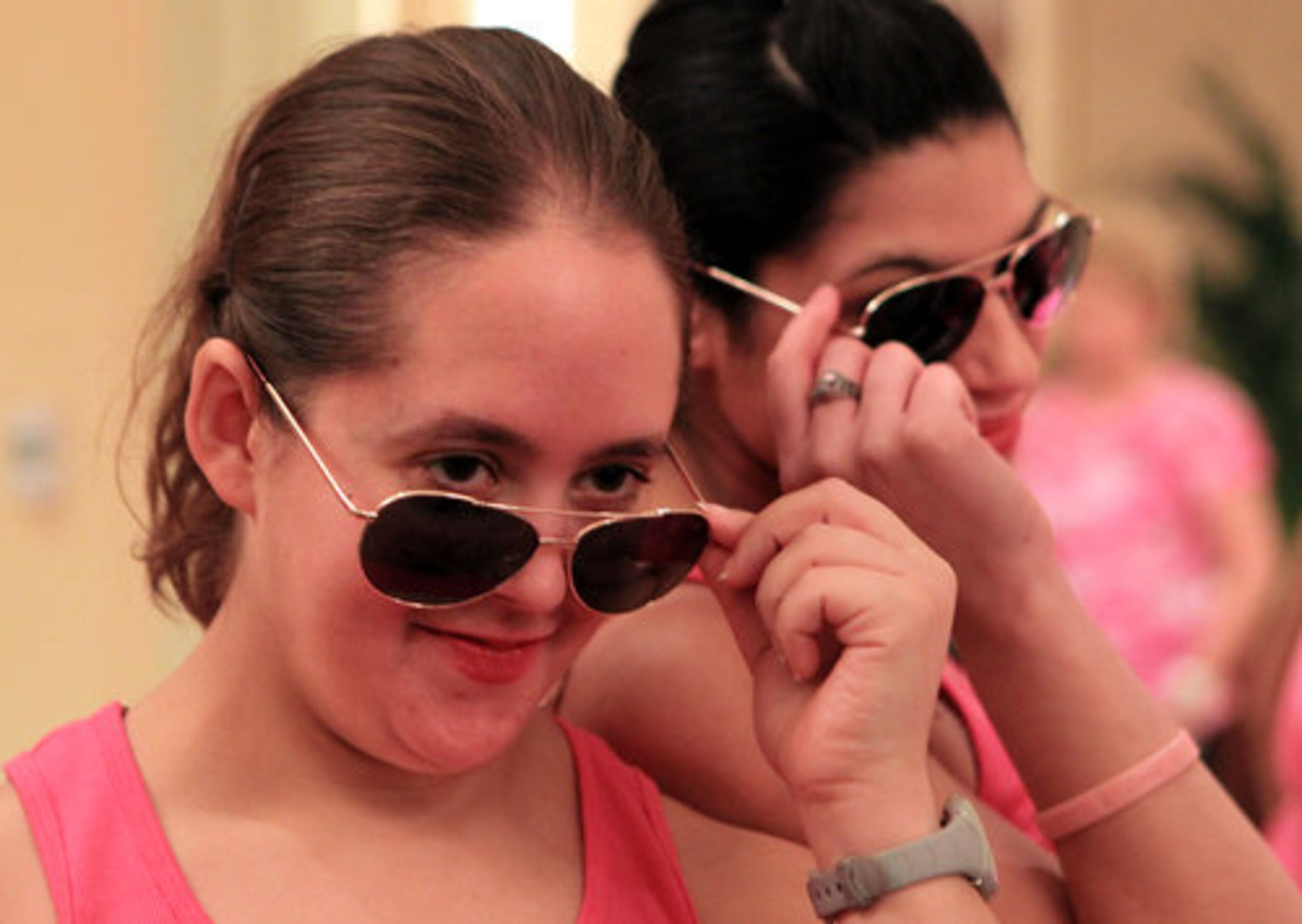 Allison Wiener, left, and Hannah Wiener, right, with Douglasville Jazzercise, show off their shades as they prepare to take the floor for the 9th annual 'Jazzerthon for the Cure.'