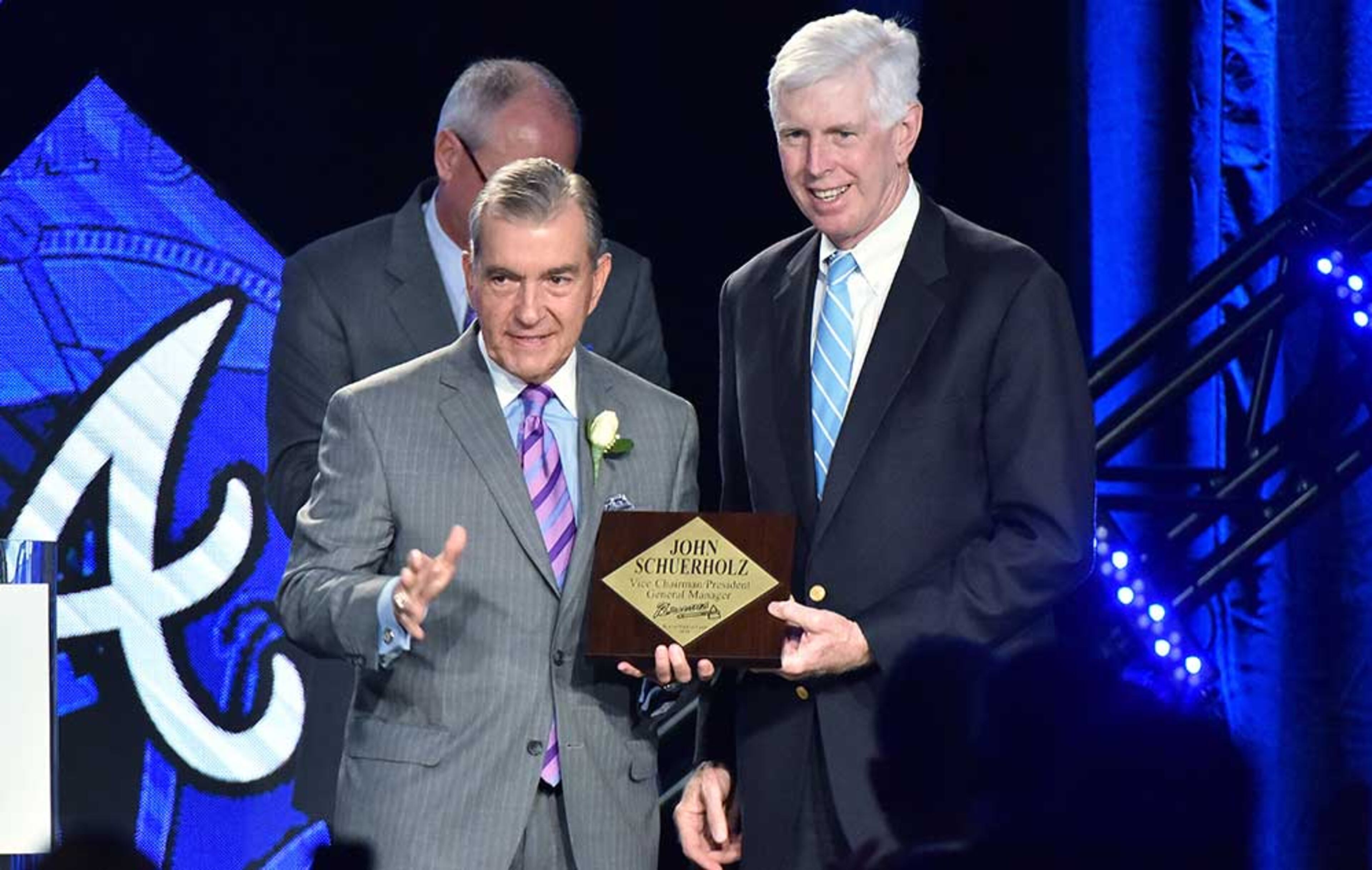 Atlanta Braves Chairman and CEO Terry McGuirk (right) presents a special plaque to Atlanta Braves President John Schuerholz during Braves Hall of Fame luncheon at Hyatt Regency on Friday, August 19, 2016. Atlanta Braves President John Schuerholz and former outfielder Andruw Jones were inducted into the Braves Hall of Fame. The duo were inducted during a luncheon and honored that evening in a pregame ceremony before the Braves play the Washington Nationals.