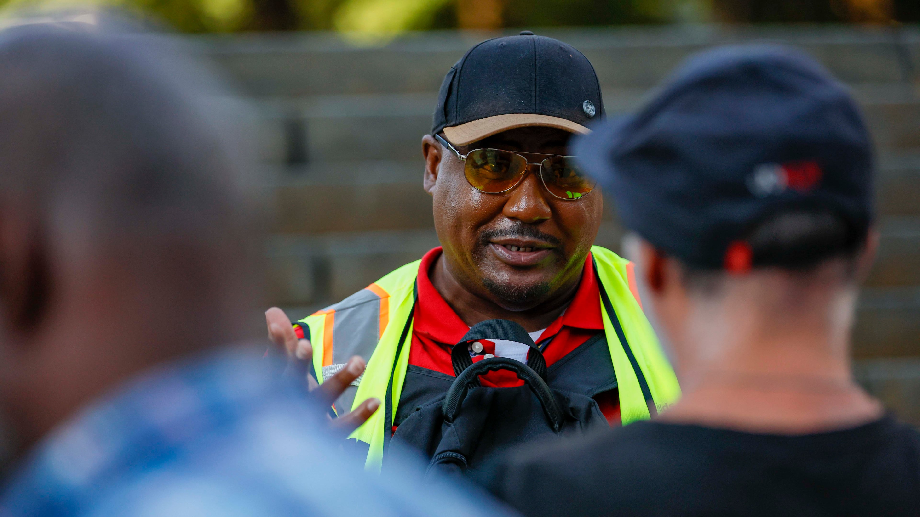 Richard DeShields (right), chair of the Client Advisory Council for Partners for Home, conducts a survey of unsheltered people at Woodruff Park on Monday, July 7, 2025. This survey will help inform Partners for Home's strategy for assisting the homeless, as well as the controversial "Downtown Rising" plan to provide shelter for the homeless in downtown before the World Cup in 2026. (Miguel Martinez/AJC)