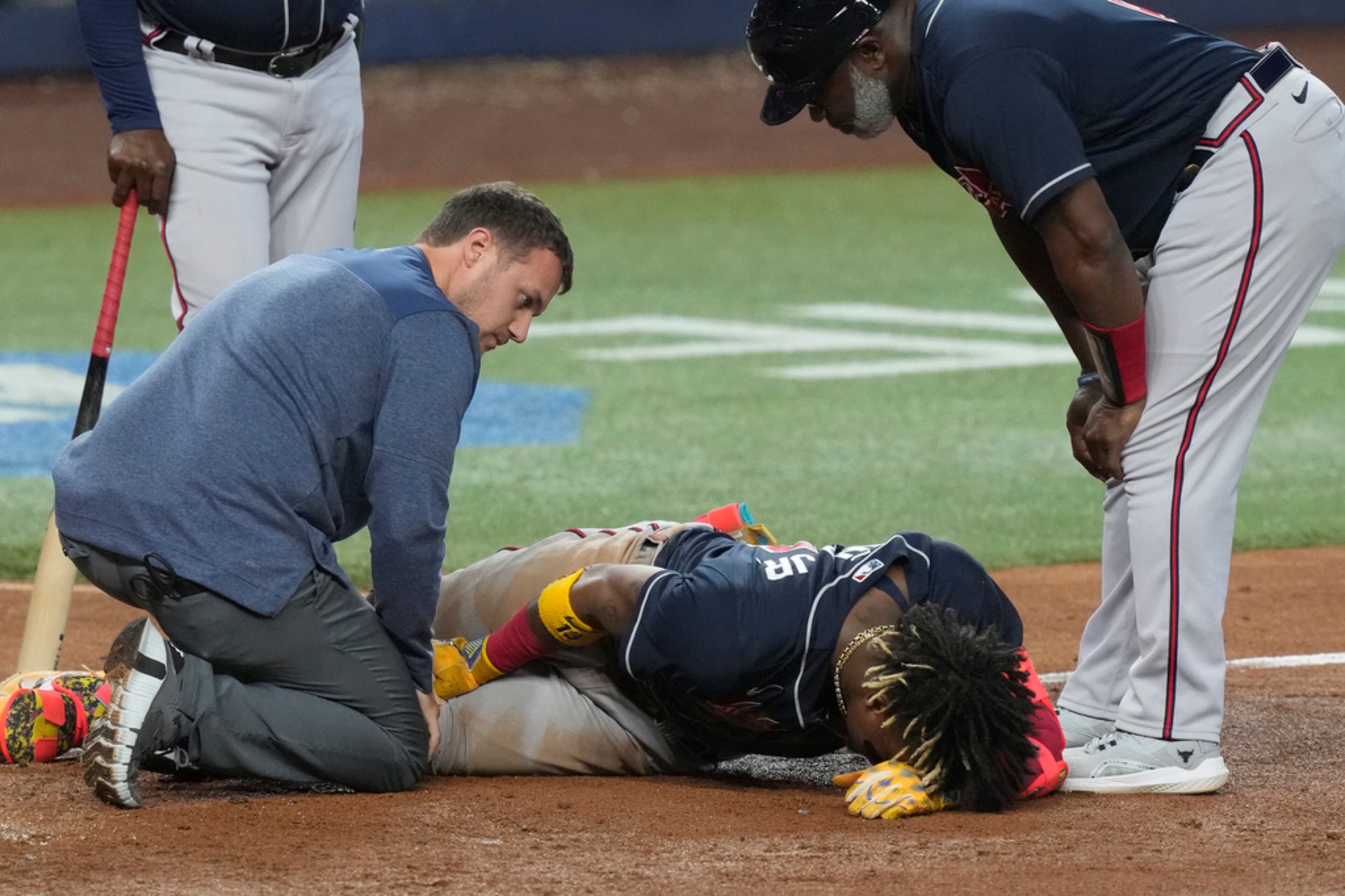 Atlanta Braves Ronald Acuna Jr. (13) grimaces after he was hit by a ball in the left leg during the sixth inning of a baseball game against the Miami Marlins, Thursday, May 4, 2023, in Miami. (AP Photo/Marta Lavandier)