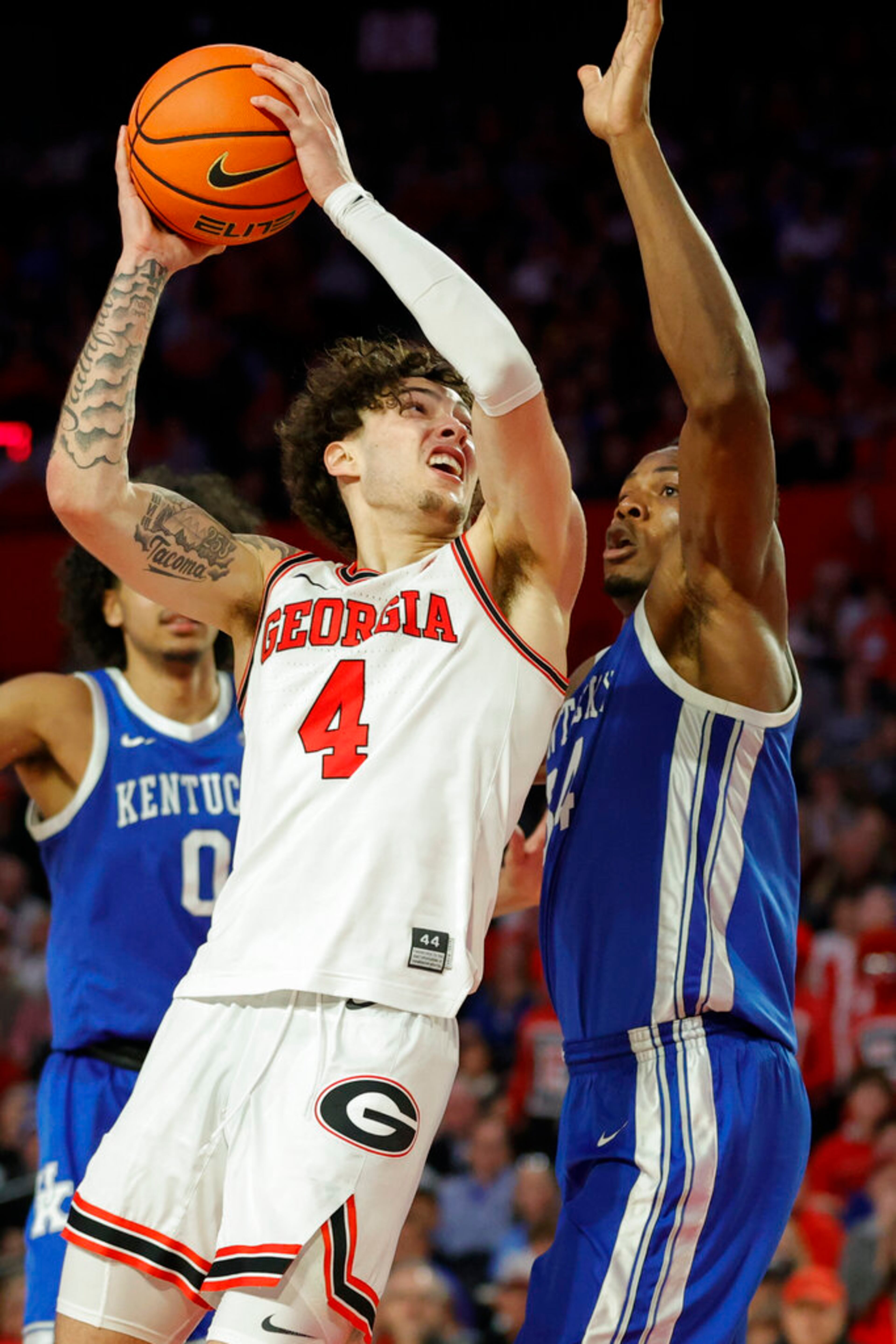 Georgia guard Jusaun Holt, left, shoots against Kentucky forward Oscar Tshiebwe, right, during the second half of an NCAA college basketball game, Saturday, Feb. 11, 2023, in Athens, Ga. (AP Photo/Alex Slitz)