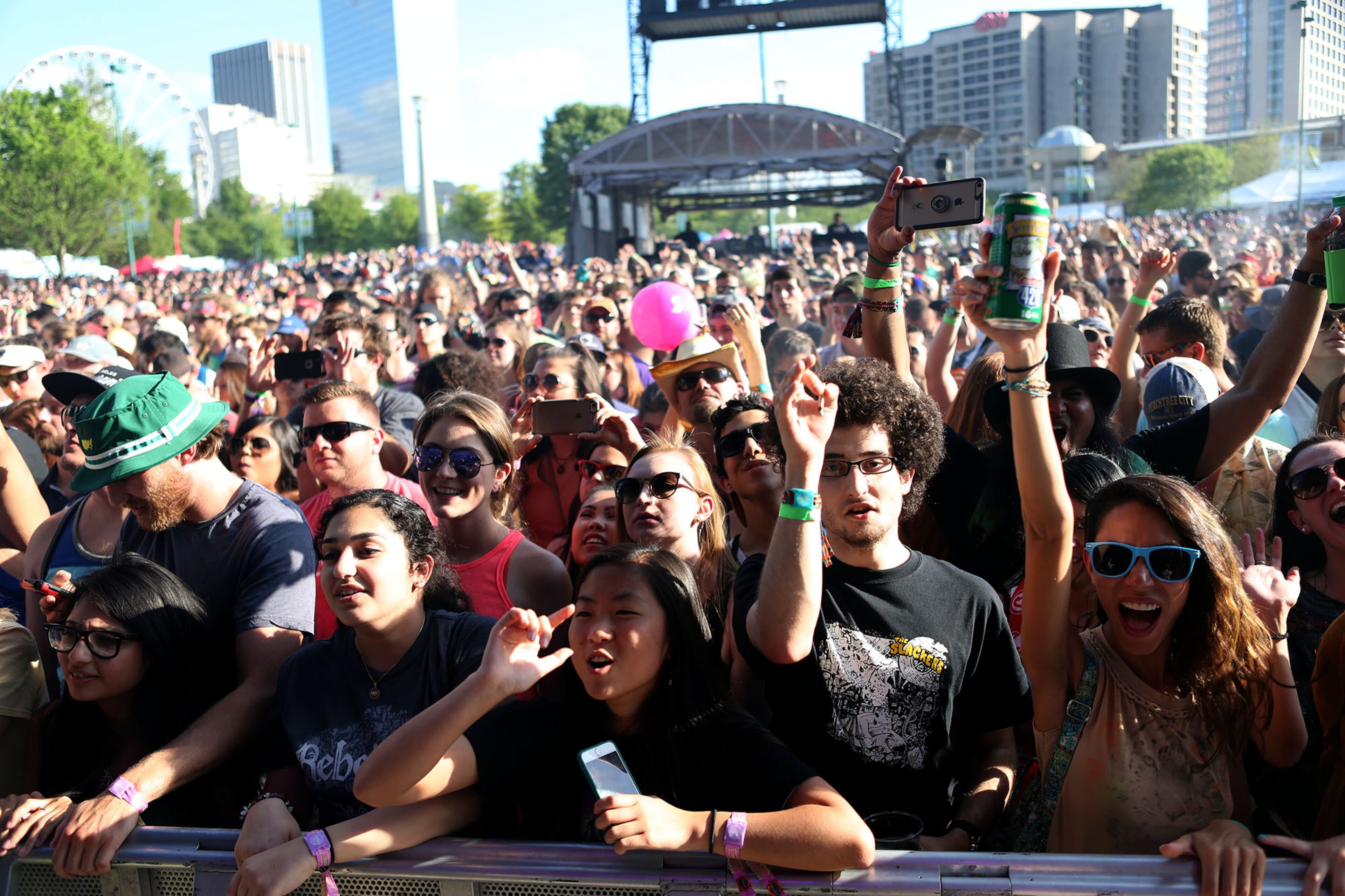 The crowds press the barricades as Rebelution takes to the stage at SweetWater 420 Fest on Saturday, April 23, 2016. (Akili-Casundria Ramsess/Special to the AJC)