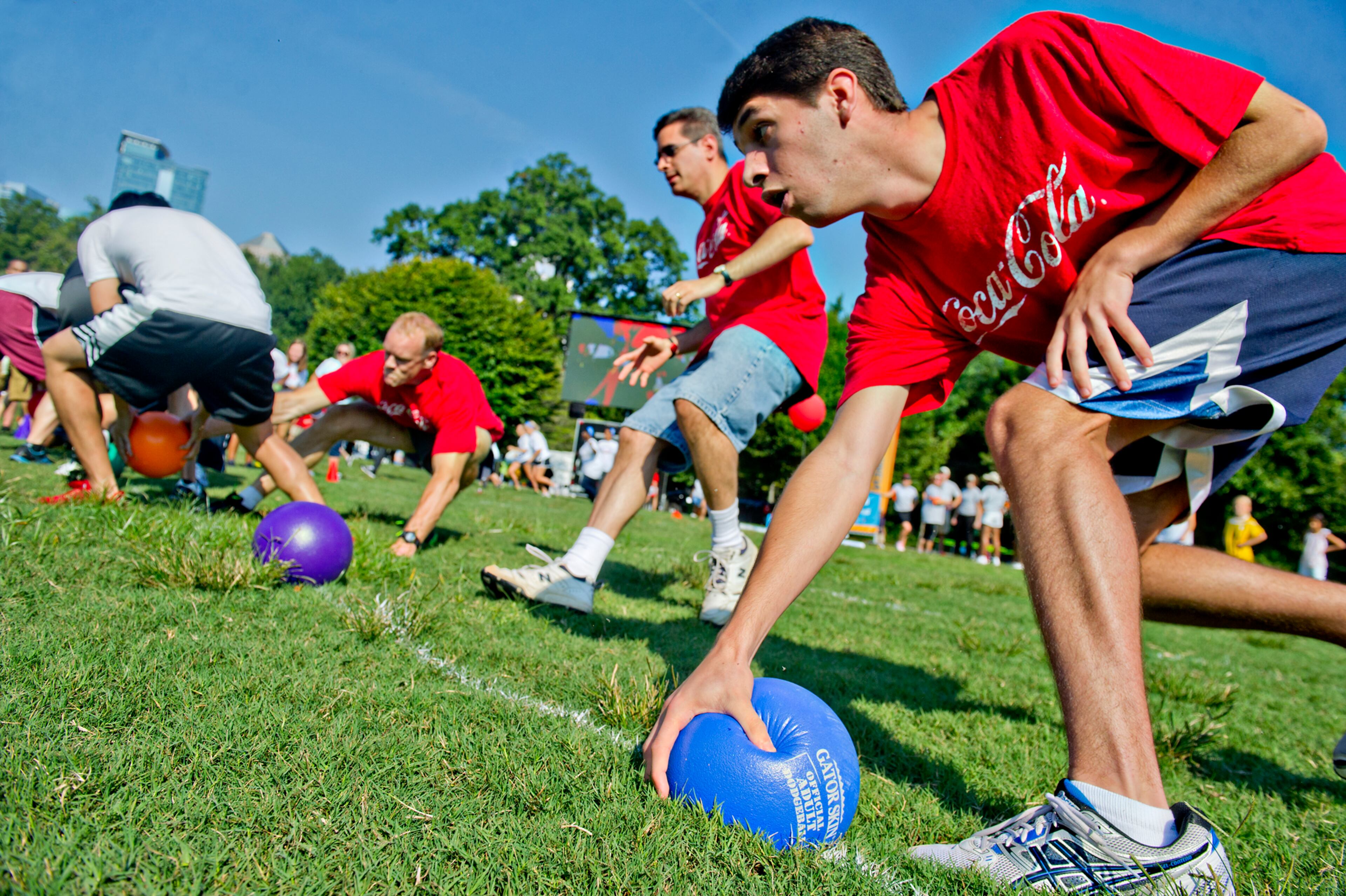 David Martin (right), Louis Martin and Clay Tippins race to grab balls at the start of a game of dodgeball during the Boys & Girls Clubs of America's Day for Kids at Piedmont Park in Atlanta on Saturday, September 7, 2013. Day for Kids is a national initiative to raise awareness for critical issues facing young men and women. With more than a decade of tradition, Day for Kids invites adults to act like kids again by participating in field day events such as relay races, dodge ball, tug of war and lots of other activities. JONATHAN PHILLIPS / SPECIAL