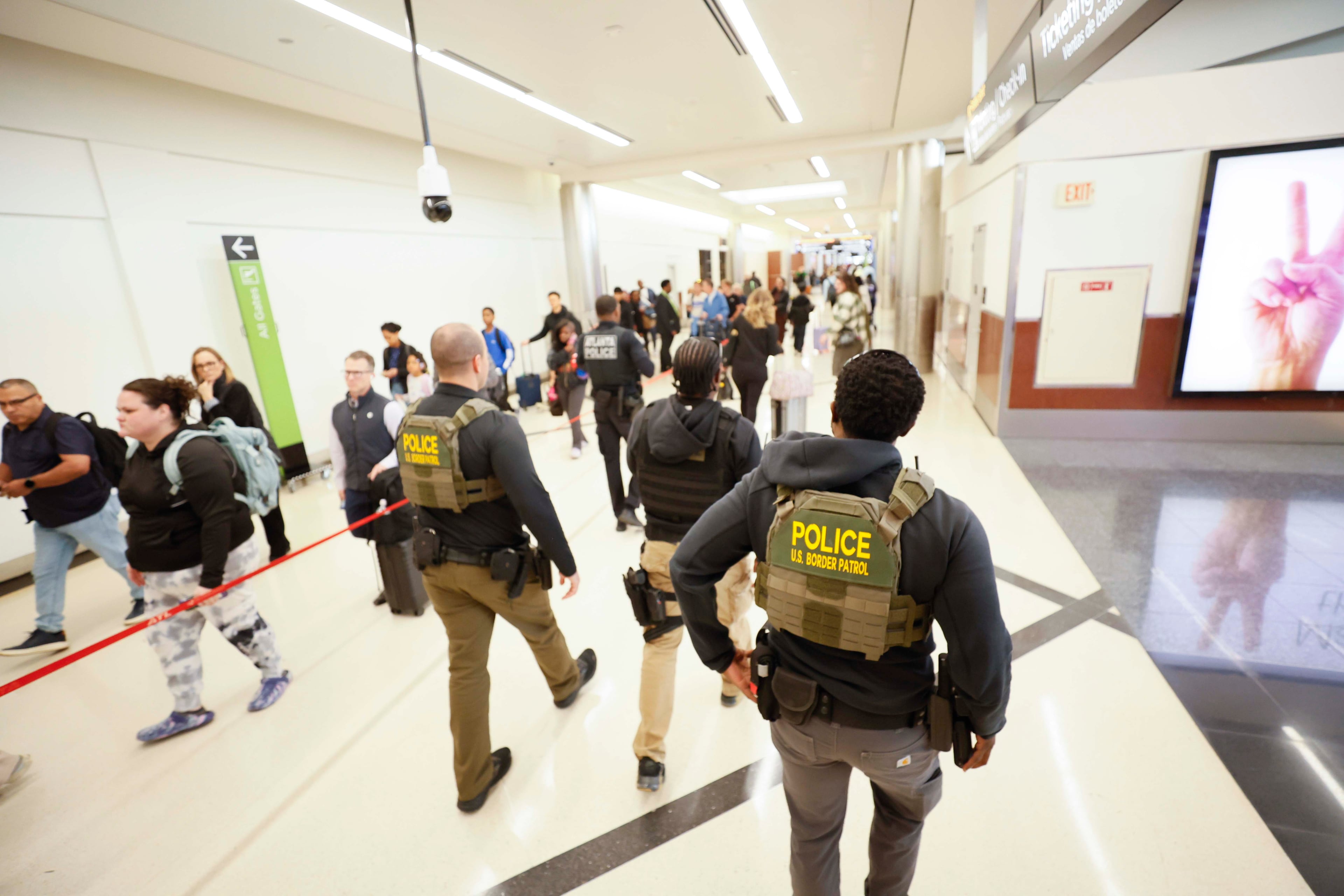 U.S. Border Patrol agents are seen walking by the North Terminal on Wednesday, March 25, 2026. The federal government deploys ICE agents to airports to assist with nonspecialized tasks in support of TSA staff. (Miguel Martinez/AJC)