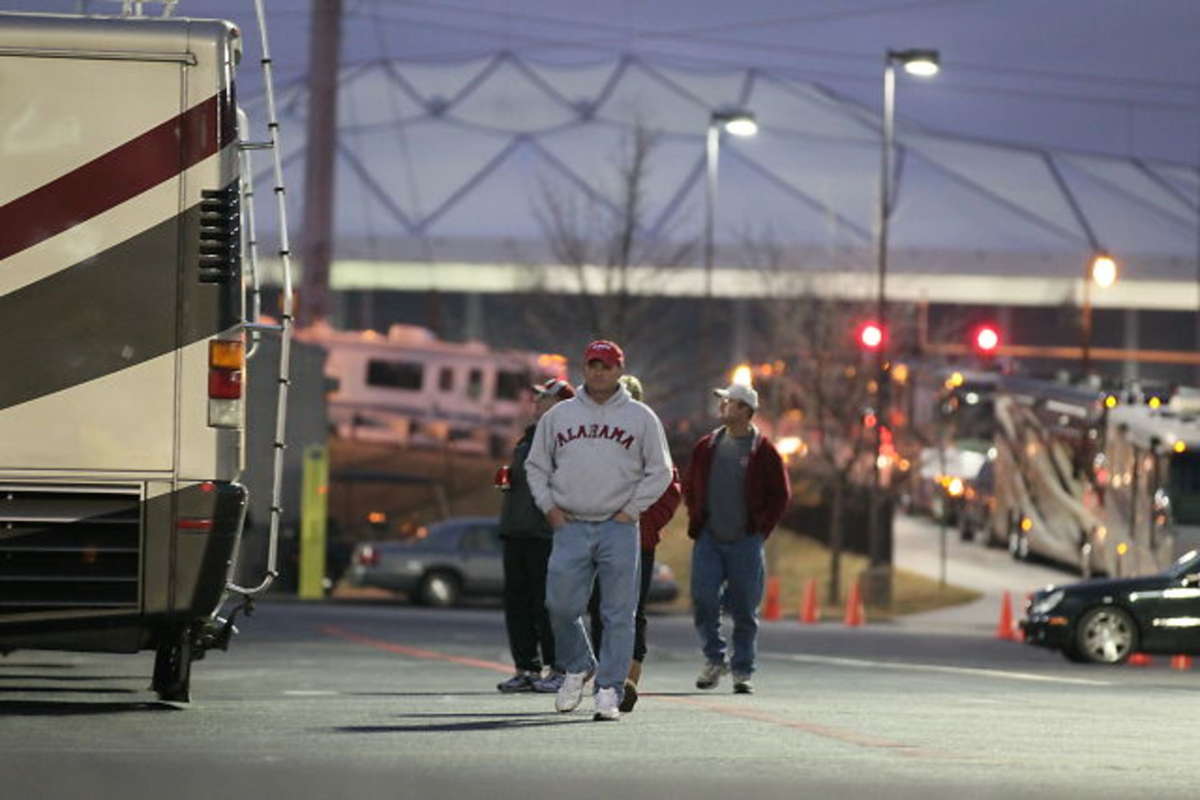 An Alabama fan strolls through the lot early Friday morning.| Tailgating at Dome has begun | Bulldogs fans excited | Complete SEC Championship coverage