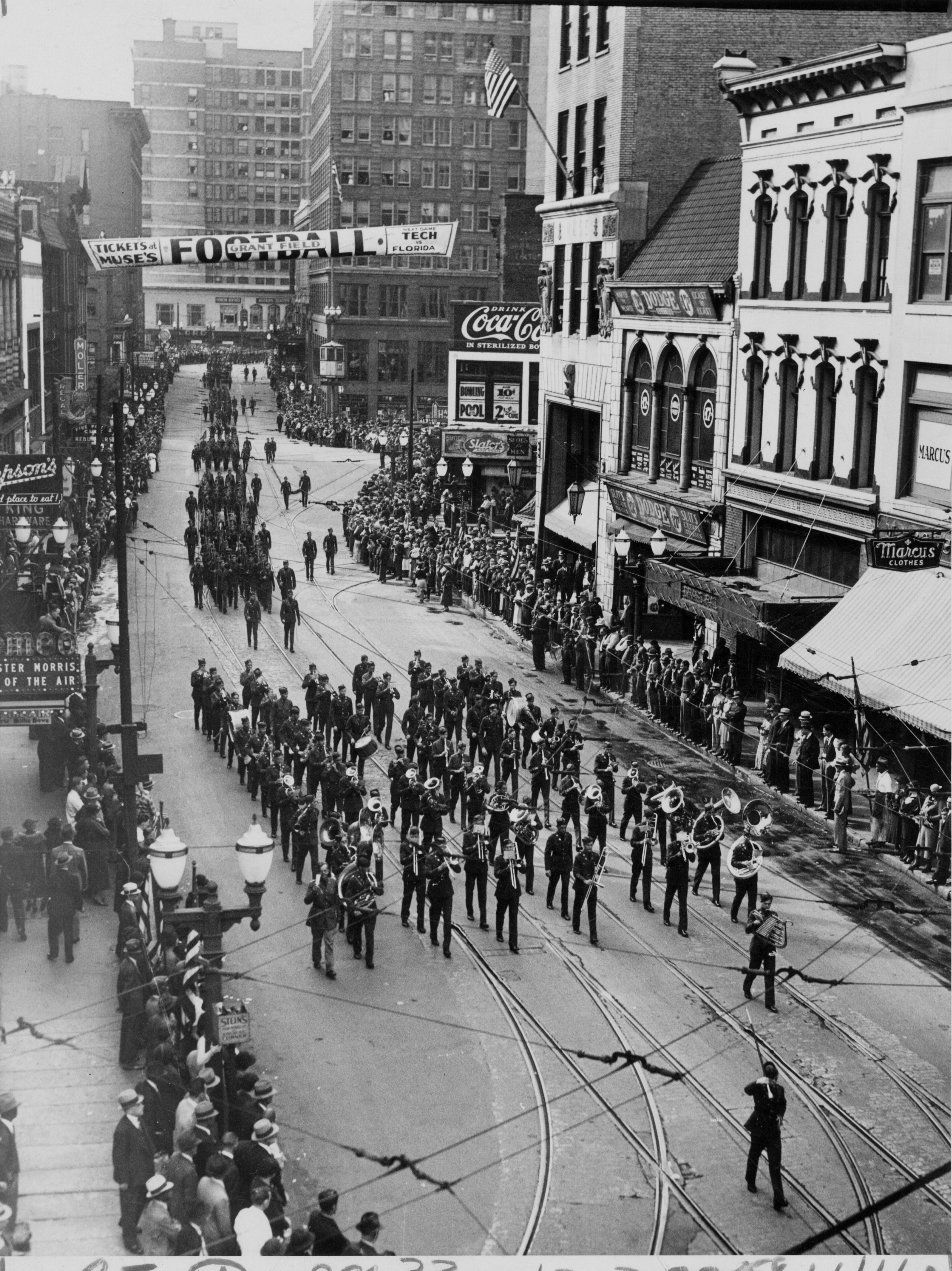 Nov. 17, 1935 - The Boys High School band leads an Armistice Day parade north on Peachtree Street, just past Five Points. The crowd lining the street that day was described as "mostly male."