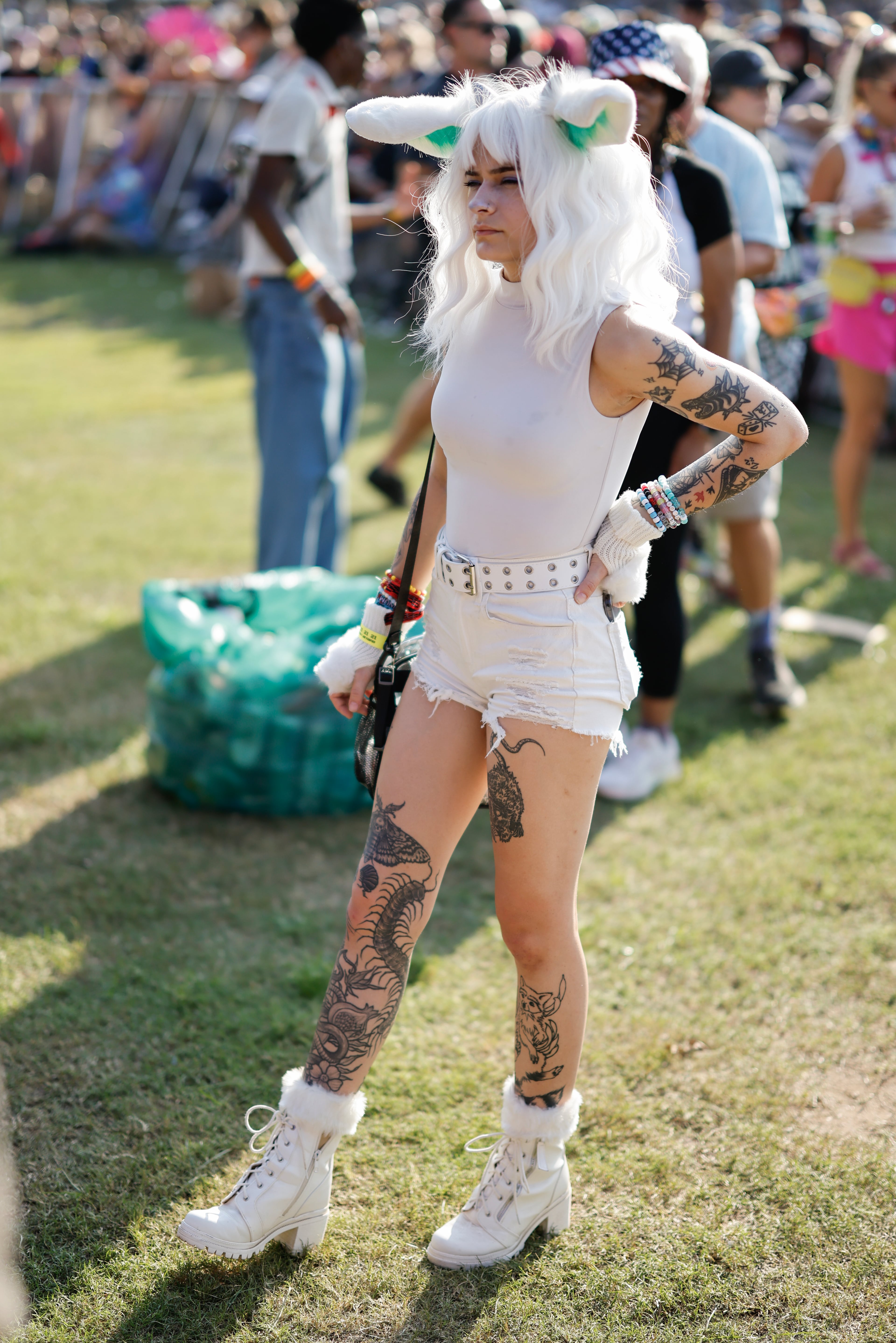A fan listens to Peach Pit perform during the Shaky Knees music festival at Piedmont Park, Saturday, Sept. 19, 2026, in Atlanta. (Erik S. Lesser for the AJC)