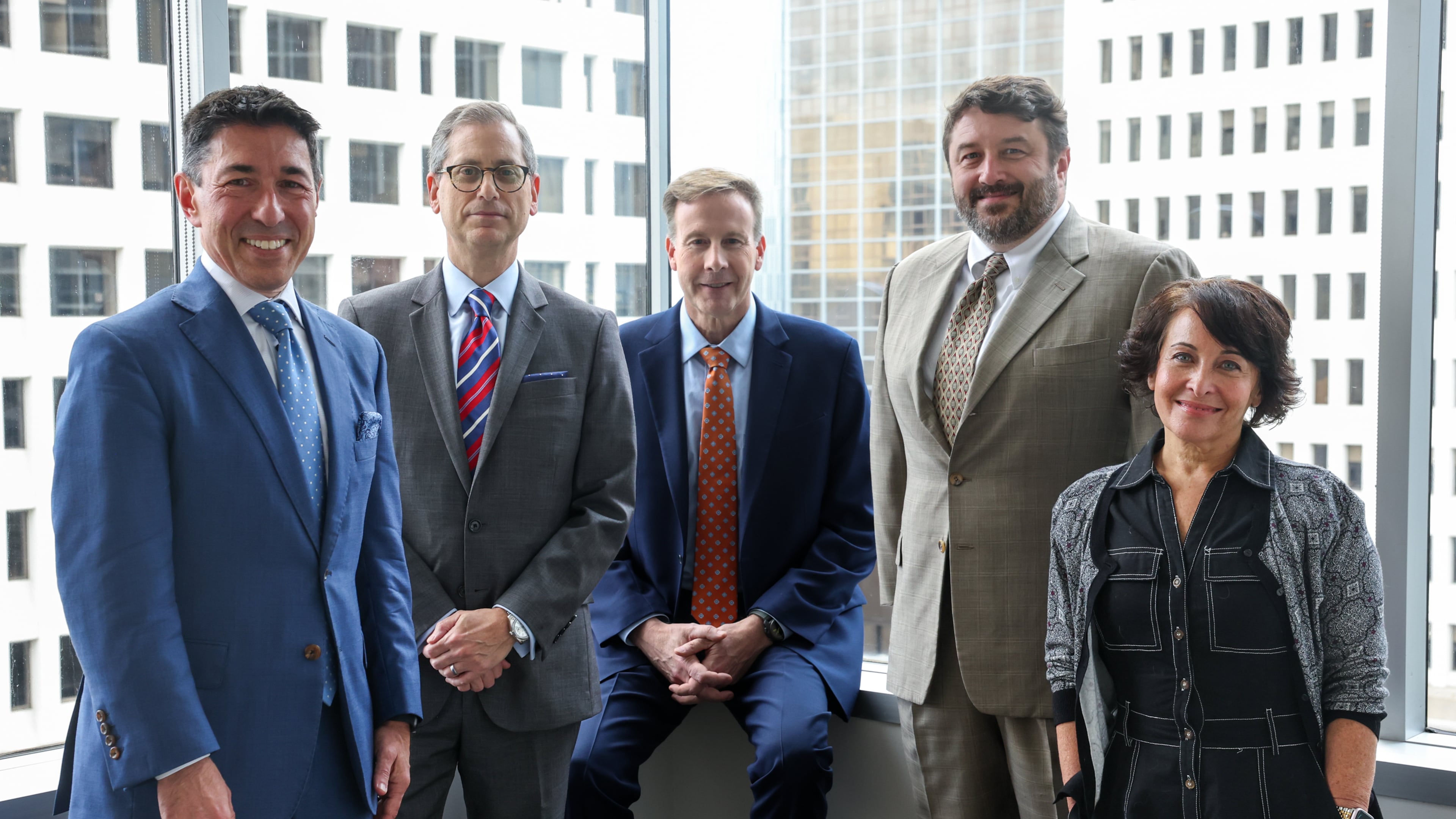 Saul Ewing staff (from left) managing partner Jason St. John, partners Steven Reingold, Patrick Tracey and Peter Hall, and communications director Leslie Gross, helped open the national law firm's Atlanta office this month in Midtown's Promenade Central building. (Arvin Temkar/AJC)