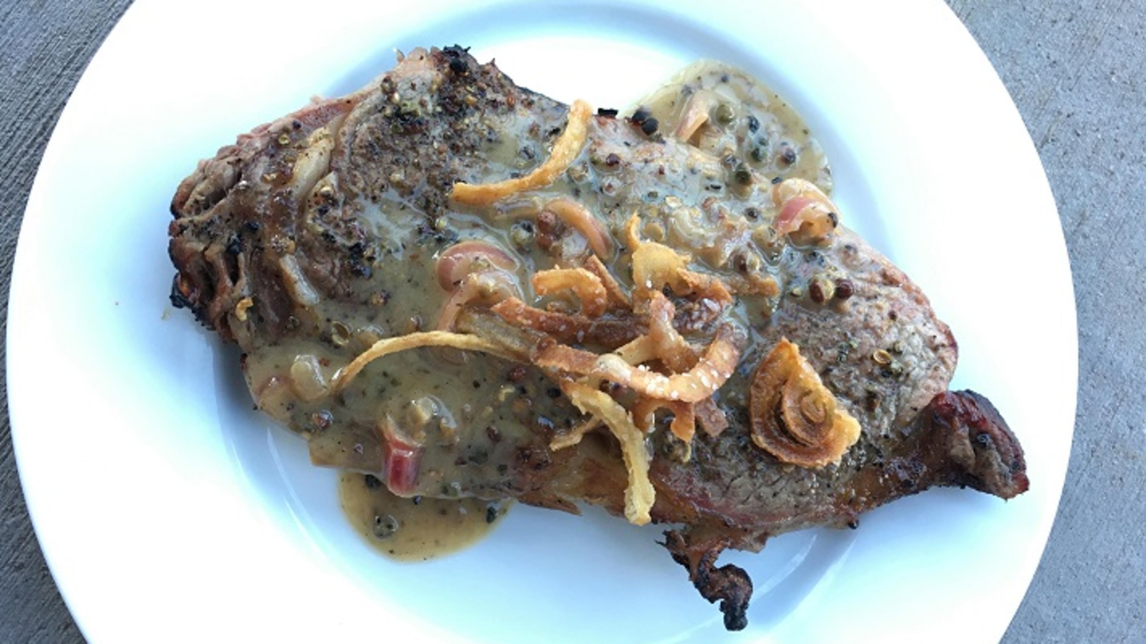 Grilled rib-eye steak with onion straws. (Lee Svitak Dean/Minneapolis Star Tribune/TNS)