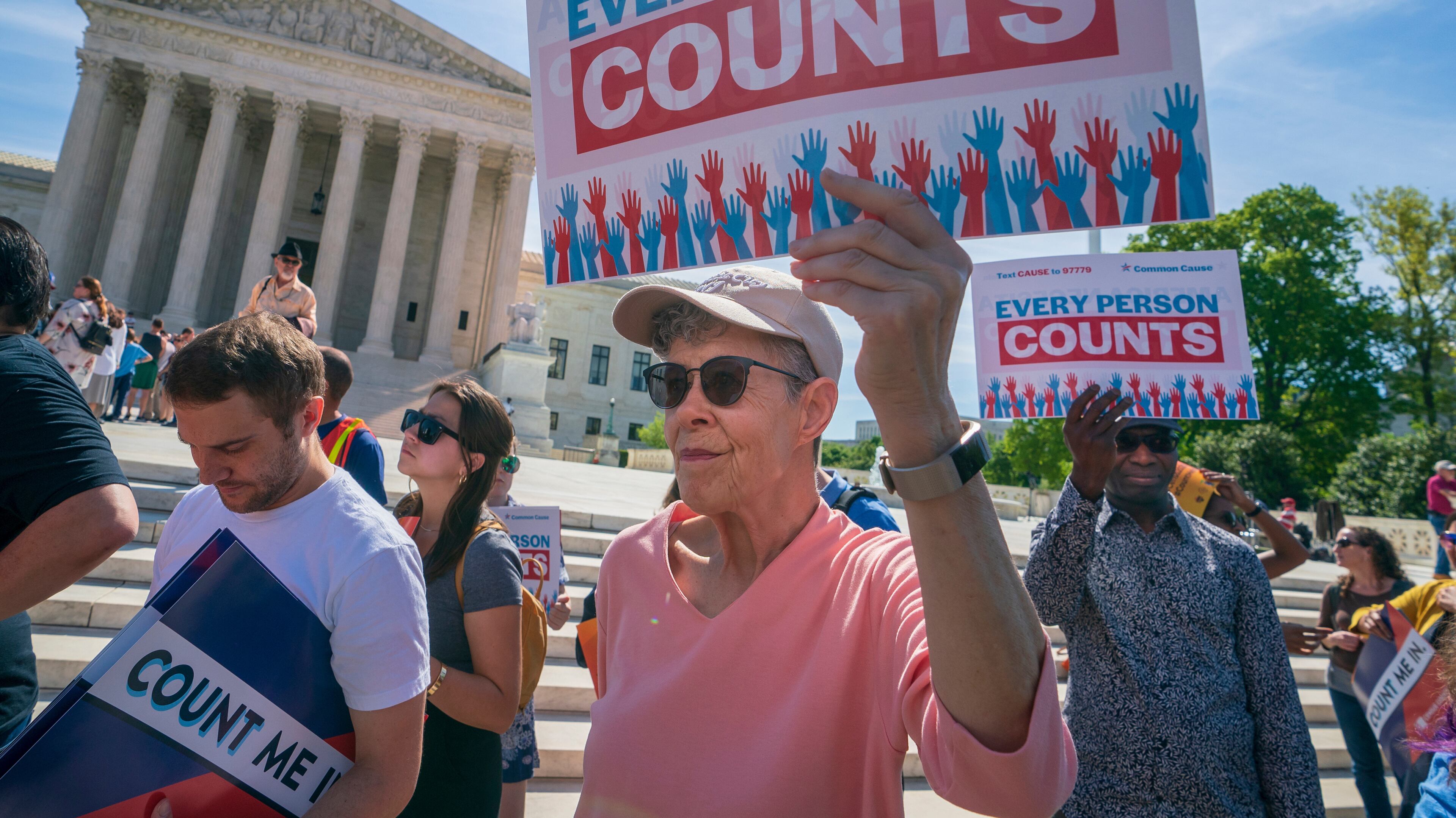 Immigration activists rally outside the Supreme Court as the justices hear arguments over the Trump administration's plan to ask about citizenship on the 2020 census, in Washington, April 23, 2019. (AP Photo/J. Scott Applewhite, File)
