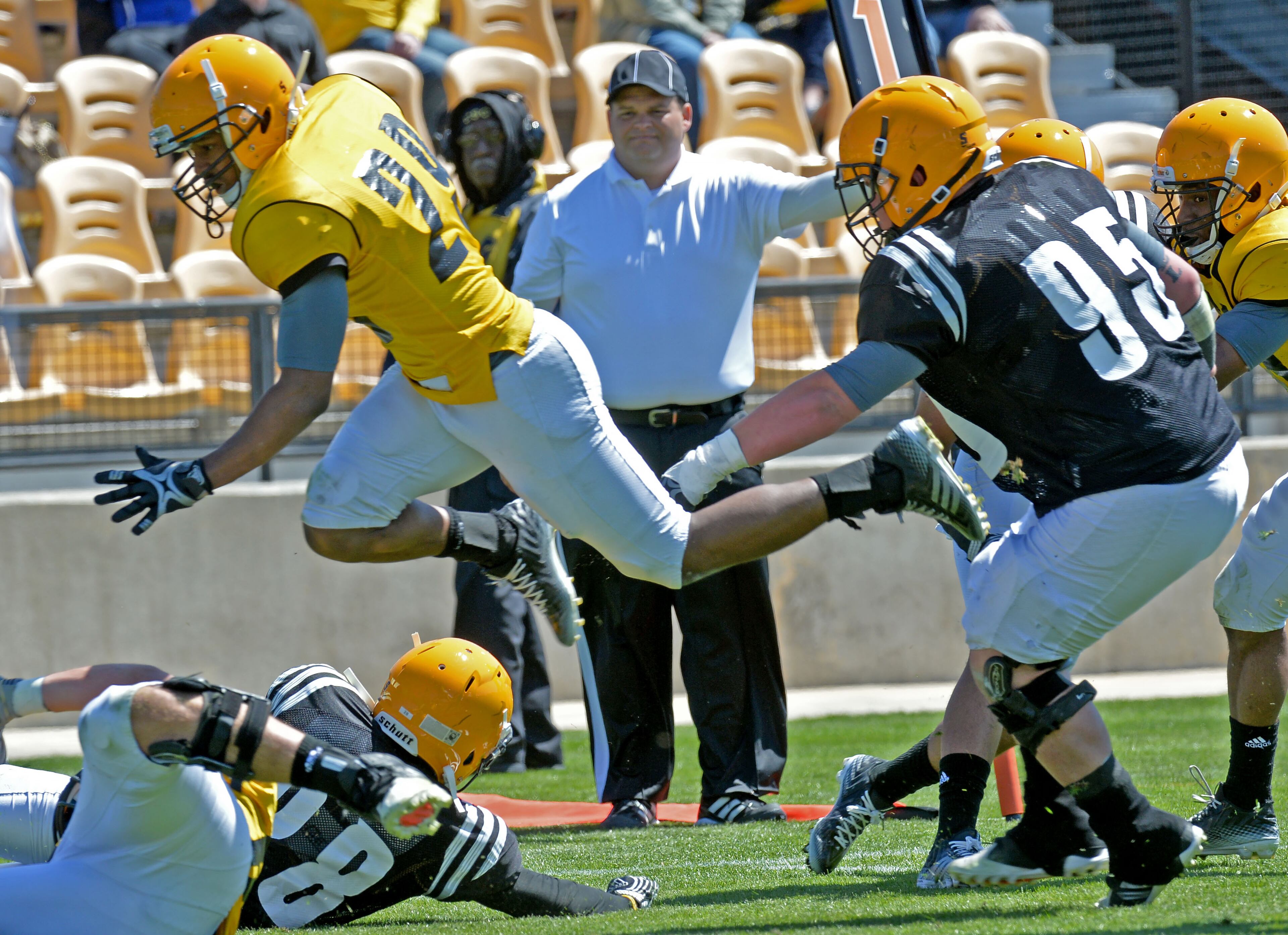 Steven Johnson (29) jumps over Will Cape (28) for a touchdown. HYOSUB SHIN / HSHIN@AJC.COM