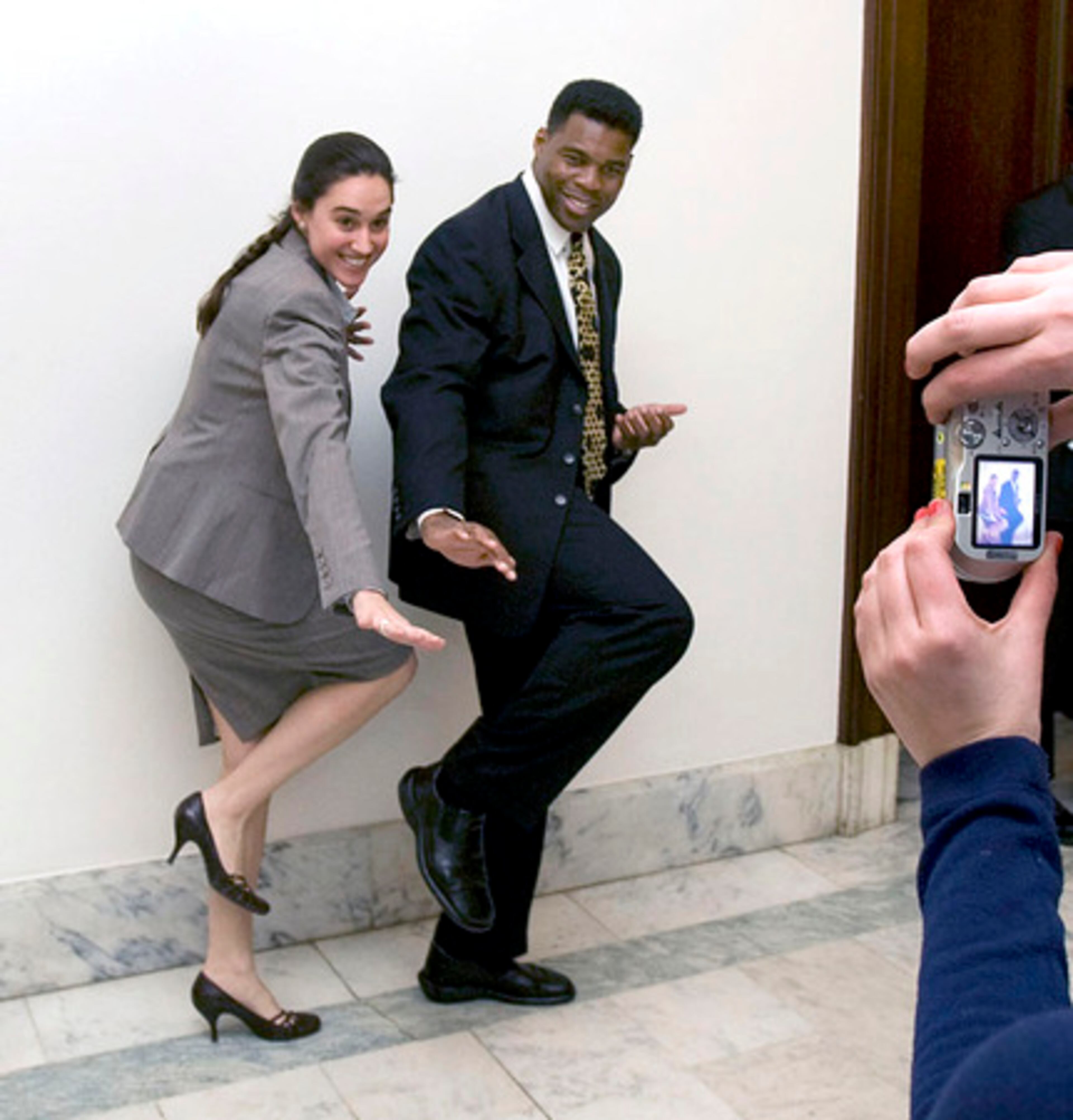 The 1982 Heisman Trophy winner strikes the signature pose with Camila Knowles, counsel for Sen. Saxby Chambliss. Walker amassed 5,097 yards in his three-year career at the University of Georgia. He was elected to the College Hall of Fame in 1999.