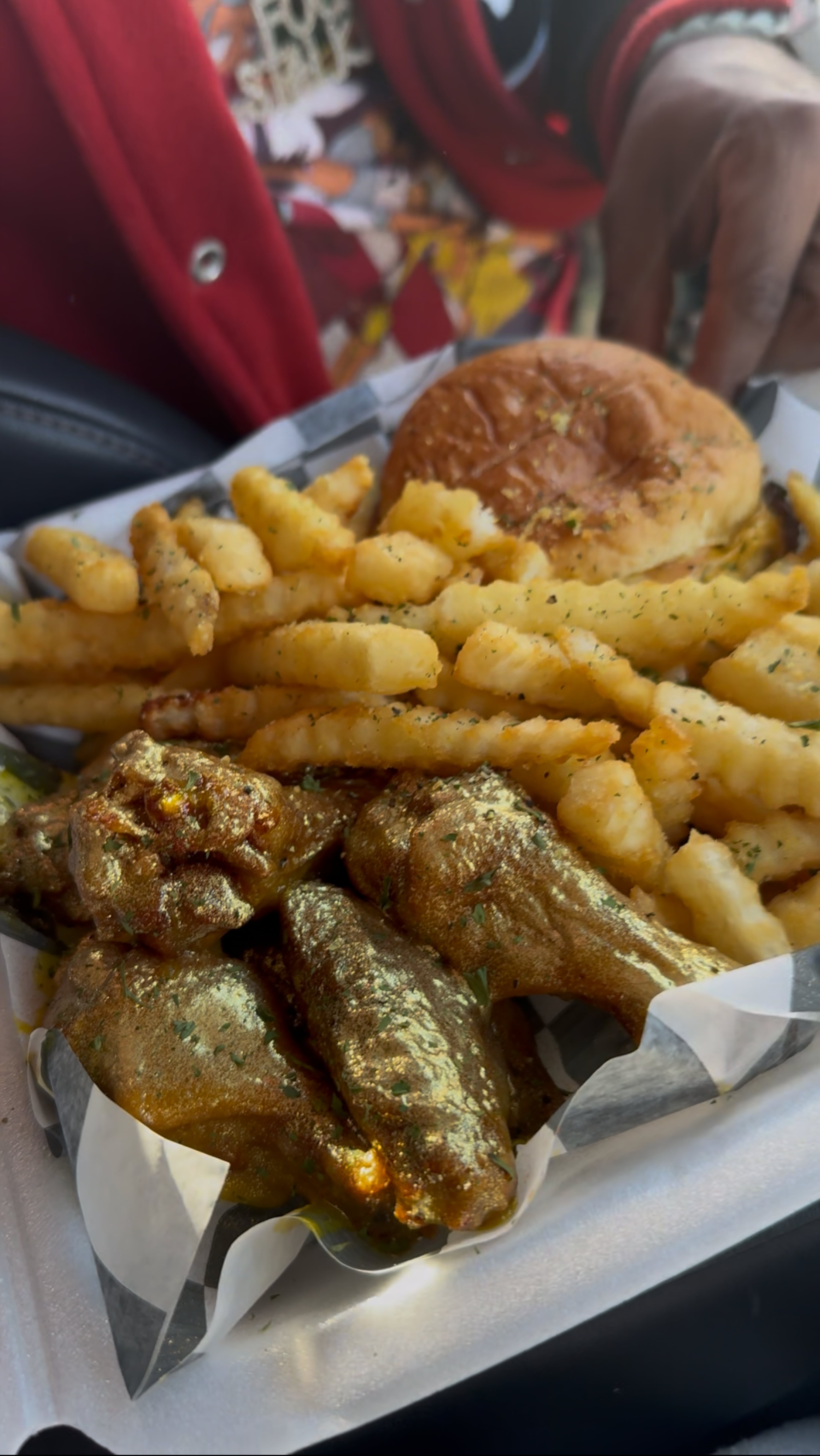 The trapper of the year meal at Trap Wingz with the restaurant's ounce of gold wings and fries. (Justin Brown for the AJC)
