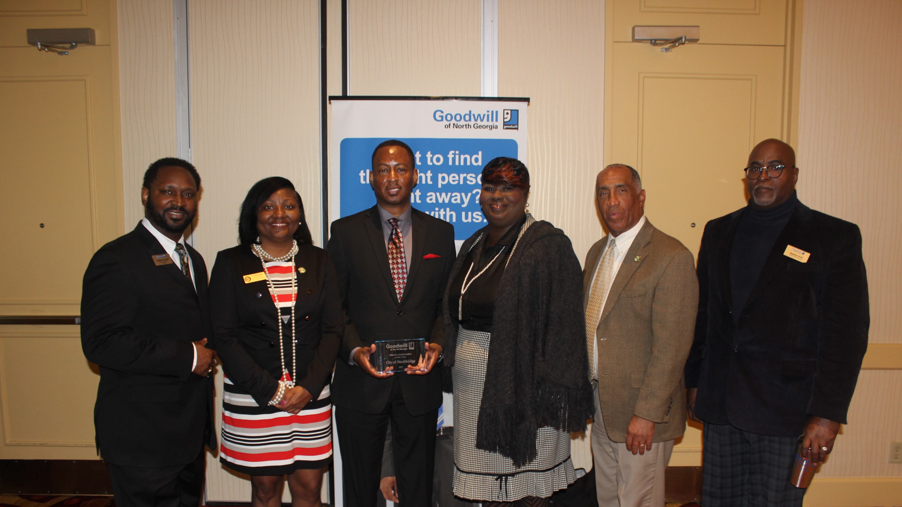 Stockbridge officials accept an award from Goodwill of North Georgia.