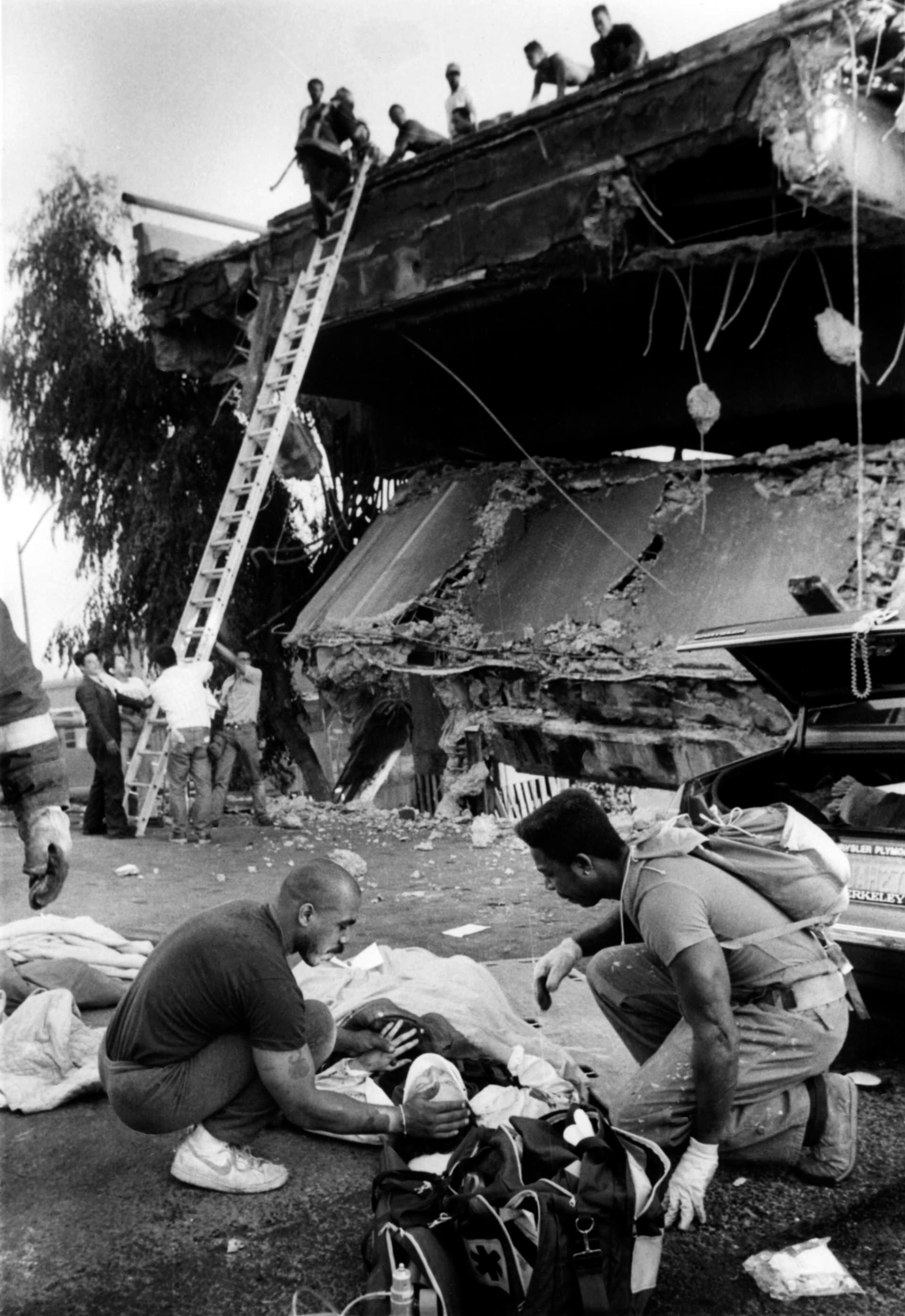 FILE: In this photo taken Oct. 17, 1989, medical personal attend to a victim of the Cypress Freeway collapse in Oakland, Calif., after the Loma Prieta earthquake. Friday is the 25th anniversary of the Loma Prieta earthquake that killed 63 people, injured almost 3,800 and caused up to $10 billion damage. (Ap Photo/Oakland Tribune, Paul Miller, file)