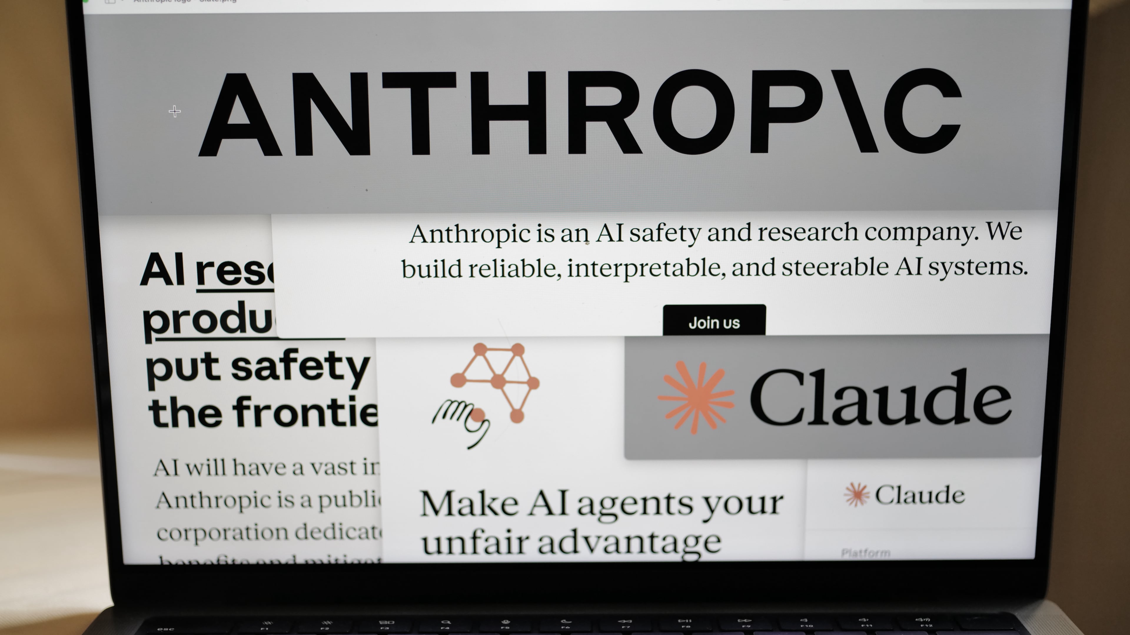FILE - Pages from the Anthropic website and the company's logos are displayed on a computer screen in New York, Feb. 26, 2026. (AP Photo/Patrick Sison, File)