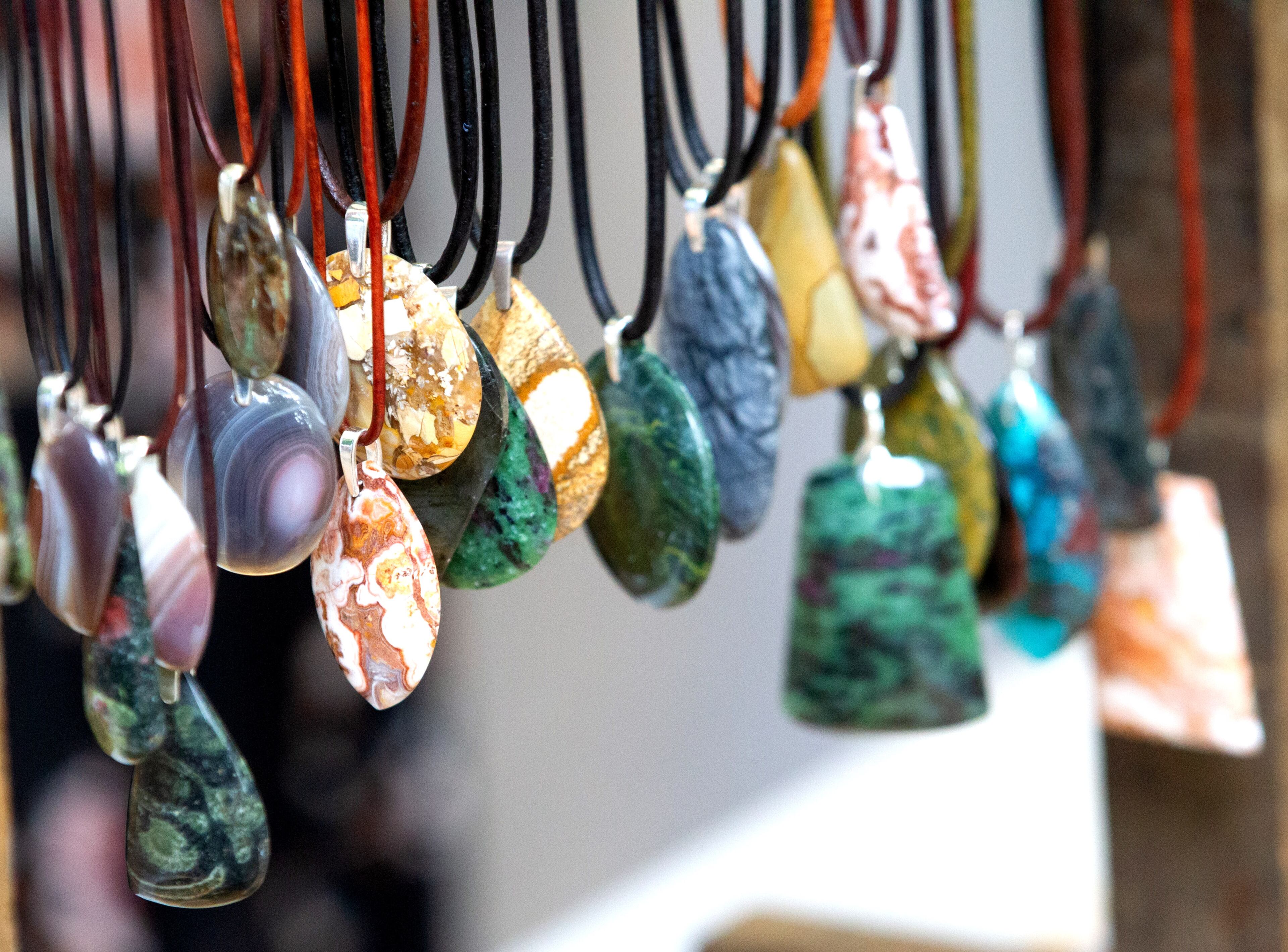 Pendants sit on display at Stone-Good Jewelry's artist tent during the Roswell Spring Arts and Crafts Festival on Sunday, June 13, 2021. (Photo: Steve Schaefer for The Atlanta Journal-Constitution)