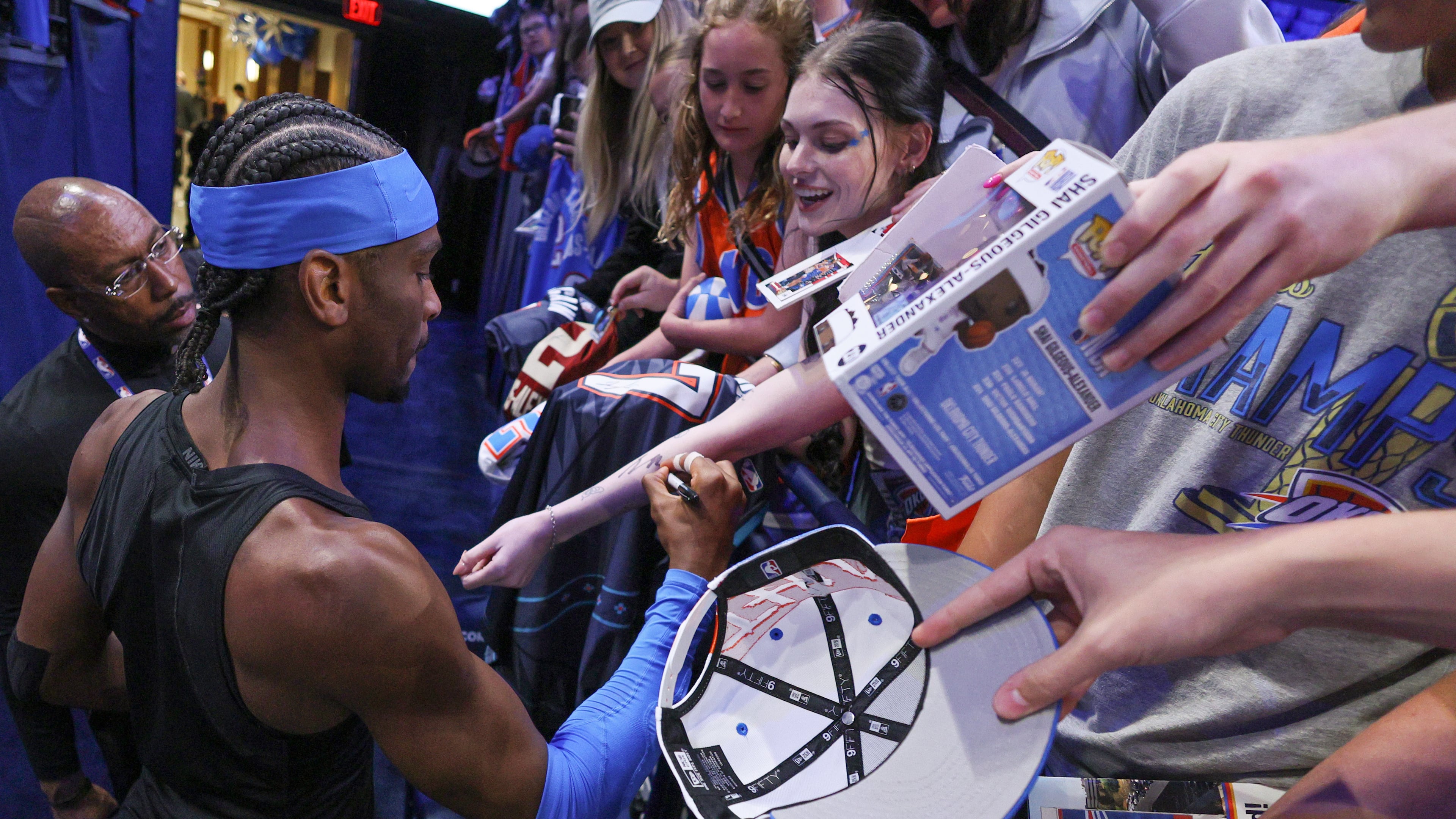 Oklahoma City Thunder guard Shai Gilgeous-Alexander, bottom left, gives autographs to fans before Game 1 of a first-round NBA playoffs basketball series against the Phoenix Suns, Sunday, April 19, 2026, in Oklahoma City. (AP Photo/Nate Billings)