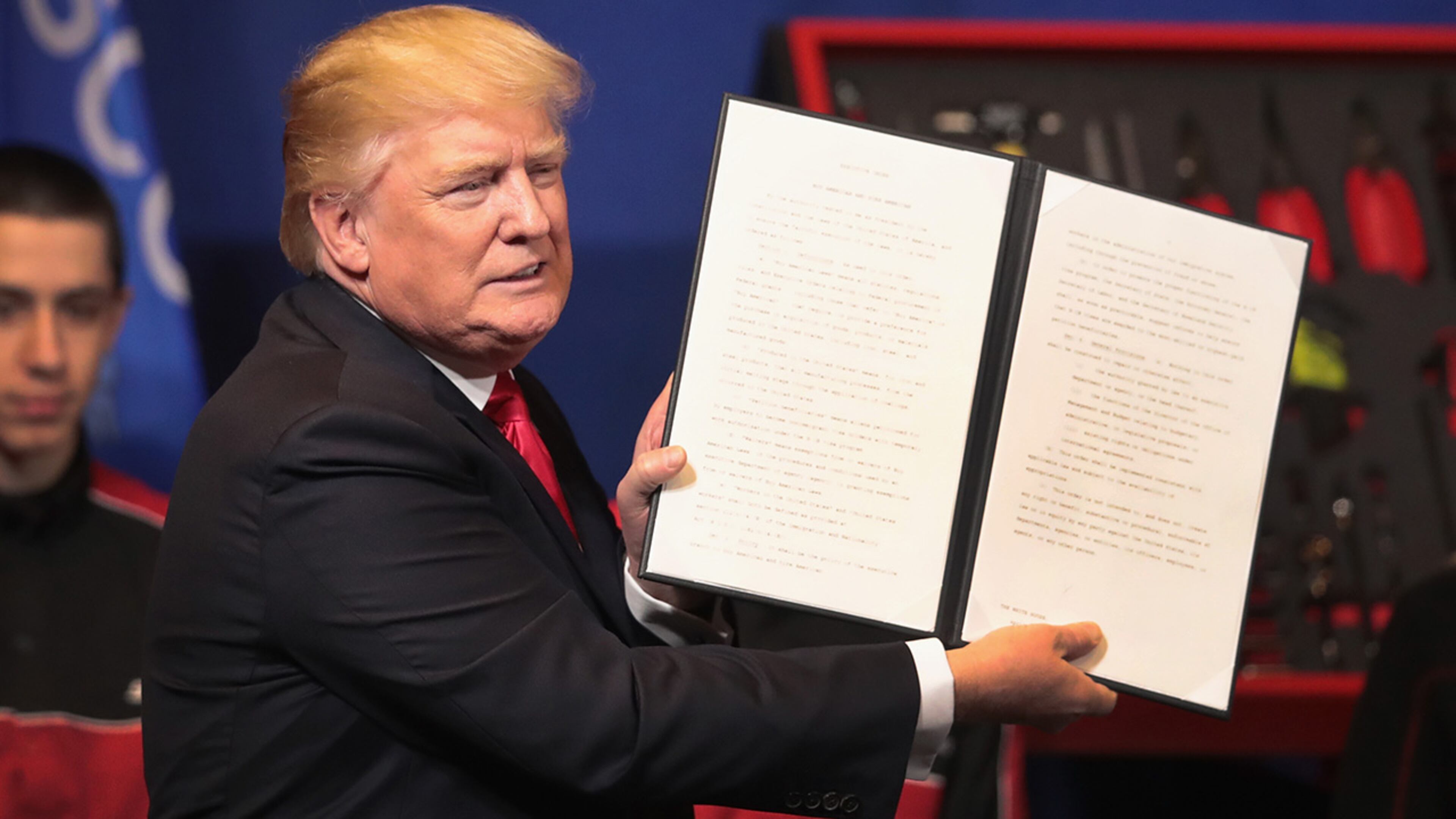 KENOSHA, WI - APRIL 18: President Donald Trump signs an executive order to try to bring jobs back to American workers and revamp the H-1B visa guest worker program during a visit to the headquarters of tool manufacturer Snap-On on April 18, 2017 in Kenosha, Wisconsin. (Photo by Scott Olson/Getty Images)