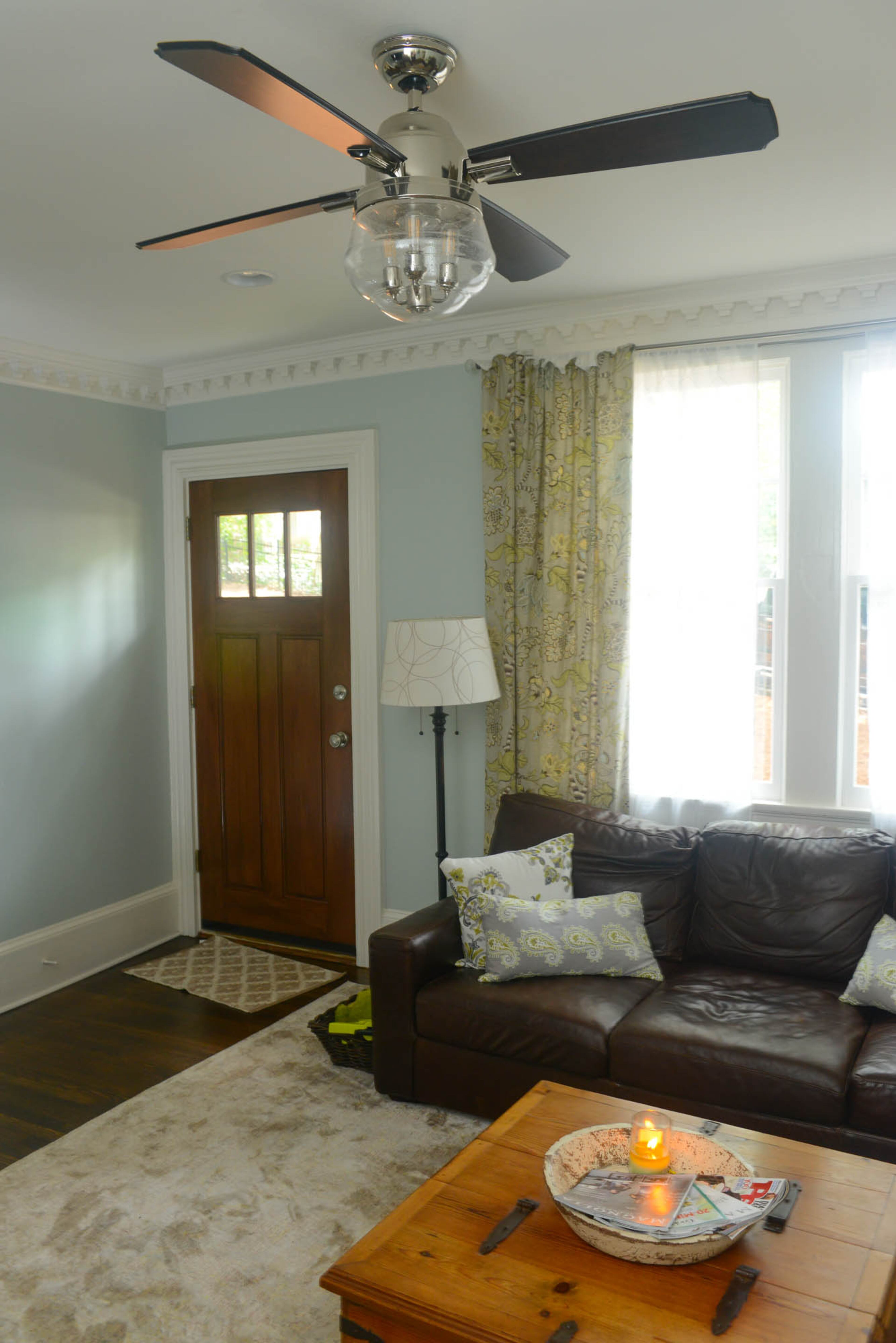 Chunky dentil molding, original to the 1928 cottage, crowns the ceiling and provides a frame for the espresso-stained Craftsman-style front door and living room windows.