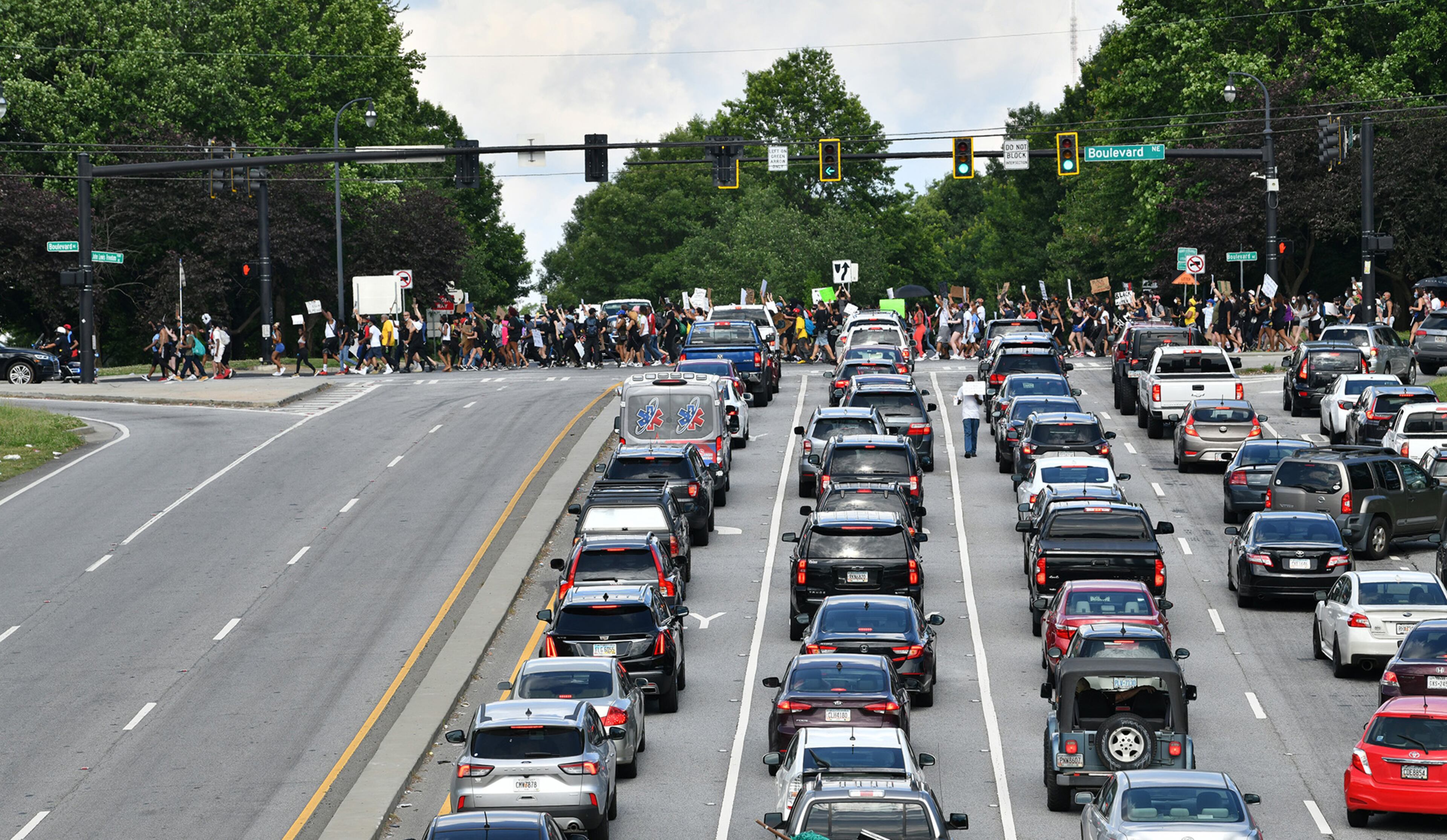 June 4, 2020 Atlanta - Protesters march down on Boulevard near Jackson Street Bridge in Atlanta on Thursday, June 4, 2020. For the seventh straight day, metro Atlanta residents are gathering for a series of protests denouncing racism and police brutality and demanding change. Sparked by the deaths of George Floyd in Minneapolis, Ahmaud Arbery in Brunswick and Breonna Taylor in Louisville, demonstrations have filled the streets of downtown Atlanta since Friday. WednesdayâÃôs protests ended largely peacefully after the cityâÃôs curfew hit. A 9 p.m. curfew is in effect in Atlanta again Thursday. (Hyosub Shin / Hyosub.Shin@ajc.com)