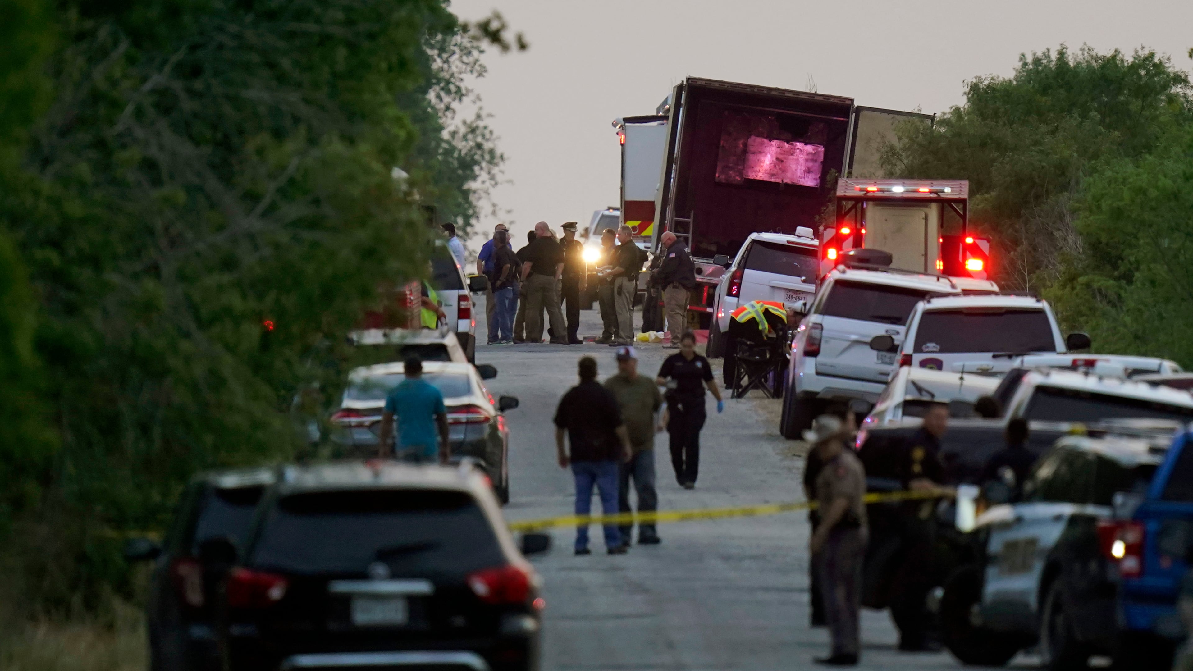 FILE - Police and other first responders work the scene where officials say dozens of people have been found dead and multiple others were taken to hospitals with heat-related illnesses after a tractor-trailer containing suspected migrants was found on June 27, 2022, in San Antonio. (AP Photo/Eric Gay, File)
