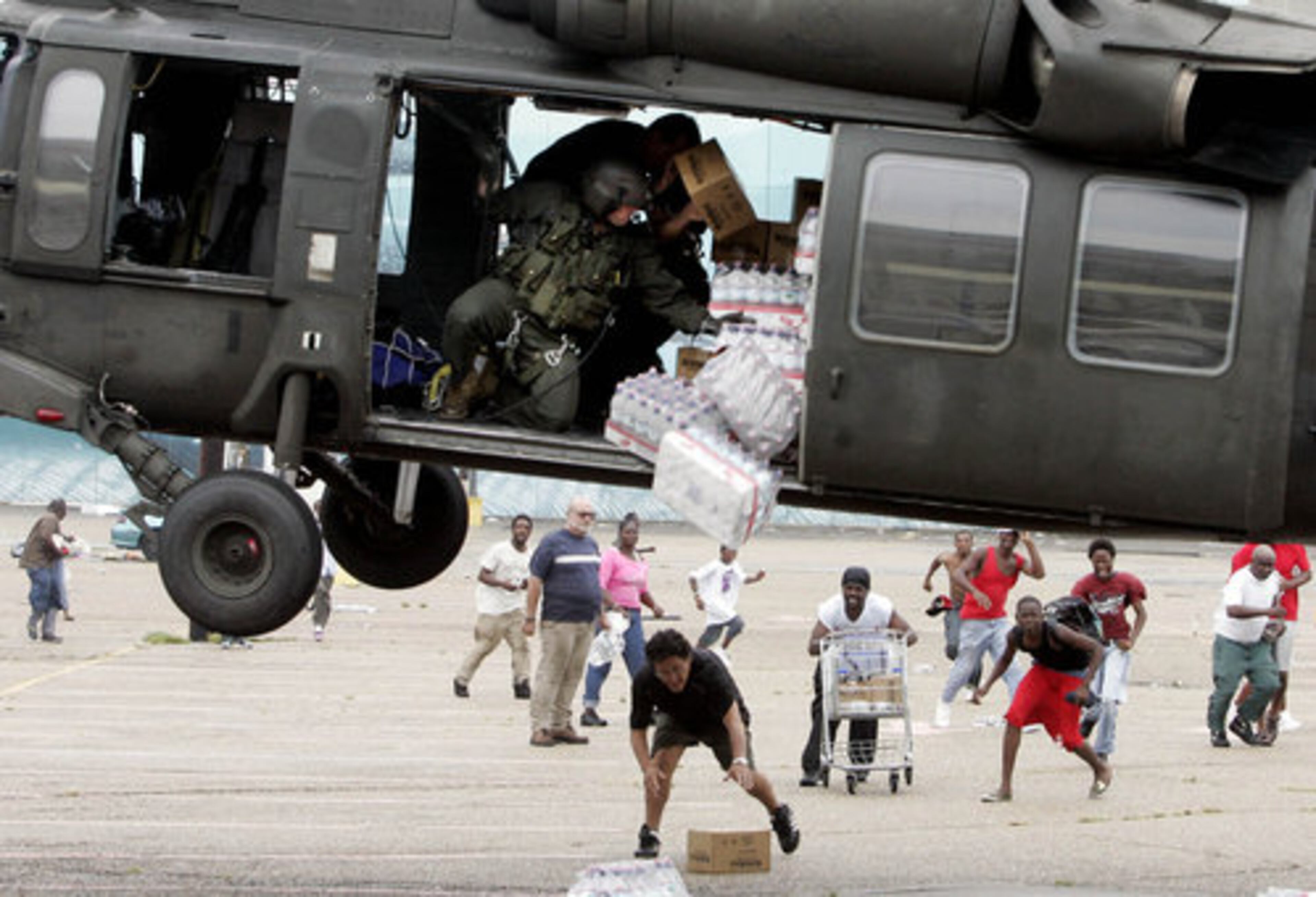 A military helicopter makes a food and water drop to survivors of Hurricane Katrina near the Convention Center in New Orleans, Thursday, Sept. 1, 2005.