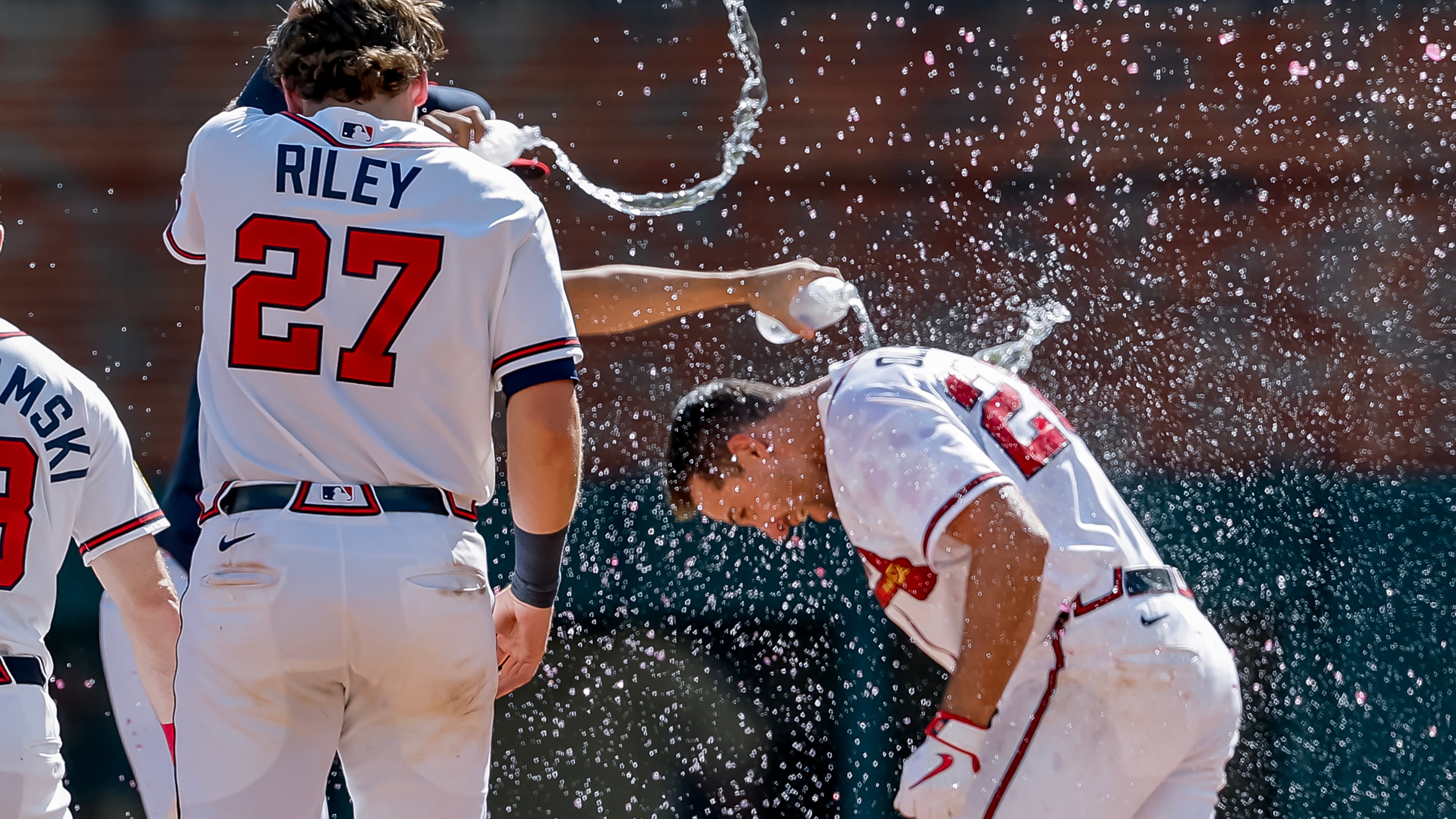 Atlanta Braves' Matt Olson, right, is doused by Austin Riley and others after he hit the winning walkoff RBI single against the Colorado Rockies during the 10th inning of a baseball game, Sunday, Aug. 30, 2026, in Atlanta. (Erik S. Lesser/AP)