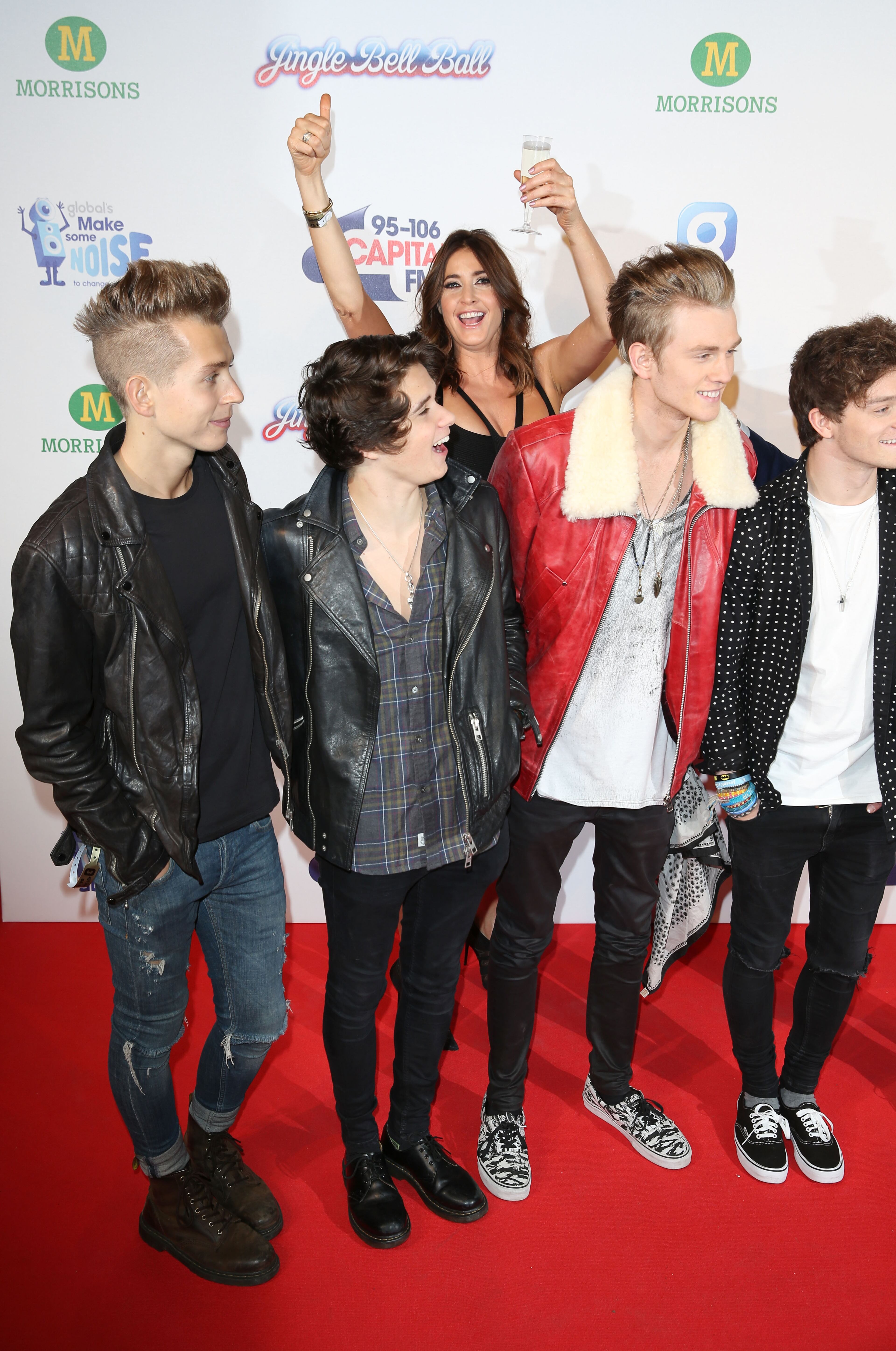 LONDON, ENGLAND - DECEMBER 06: Lisa Snowdon photobombs (L-R) James McVey, Bradley Simpson, Tristan Evans and Connor Ball of The Vamps attend the Jingle Bell Ball at 02 Arena on December 6, 2014 in London, England. (Photo by Tim P. Whitby/Getty Images)