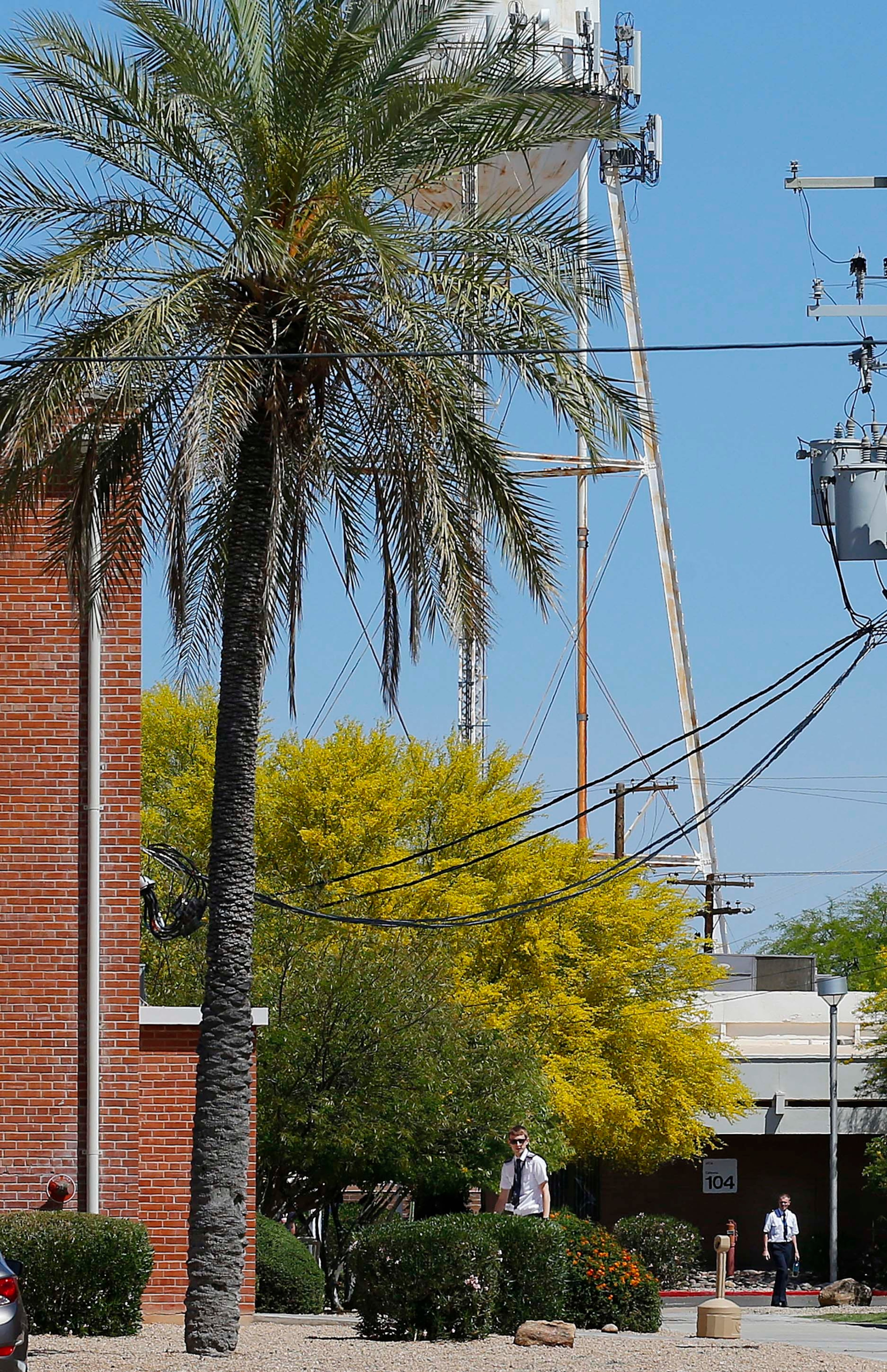 Personnel walk near the The Airline Training Center Arizona Thursday, March 26, 2015 at the Goodyear Airport in Goodyear, Ariz. German Pilot Andreas Lubitz, the co-pilot on Germanwings 9525 that crashed with 150 people on board on Tuesday in the French Alps, trained at the Airline Training Center in 2008 according to Lufthansa CEO Carsten Spohr. (AP Photo/Ross D. Franklin)