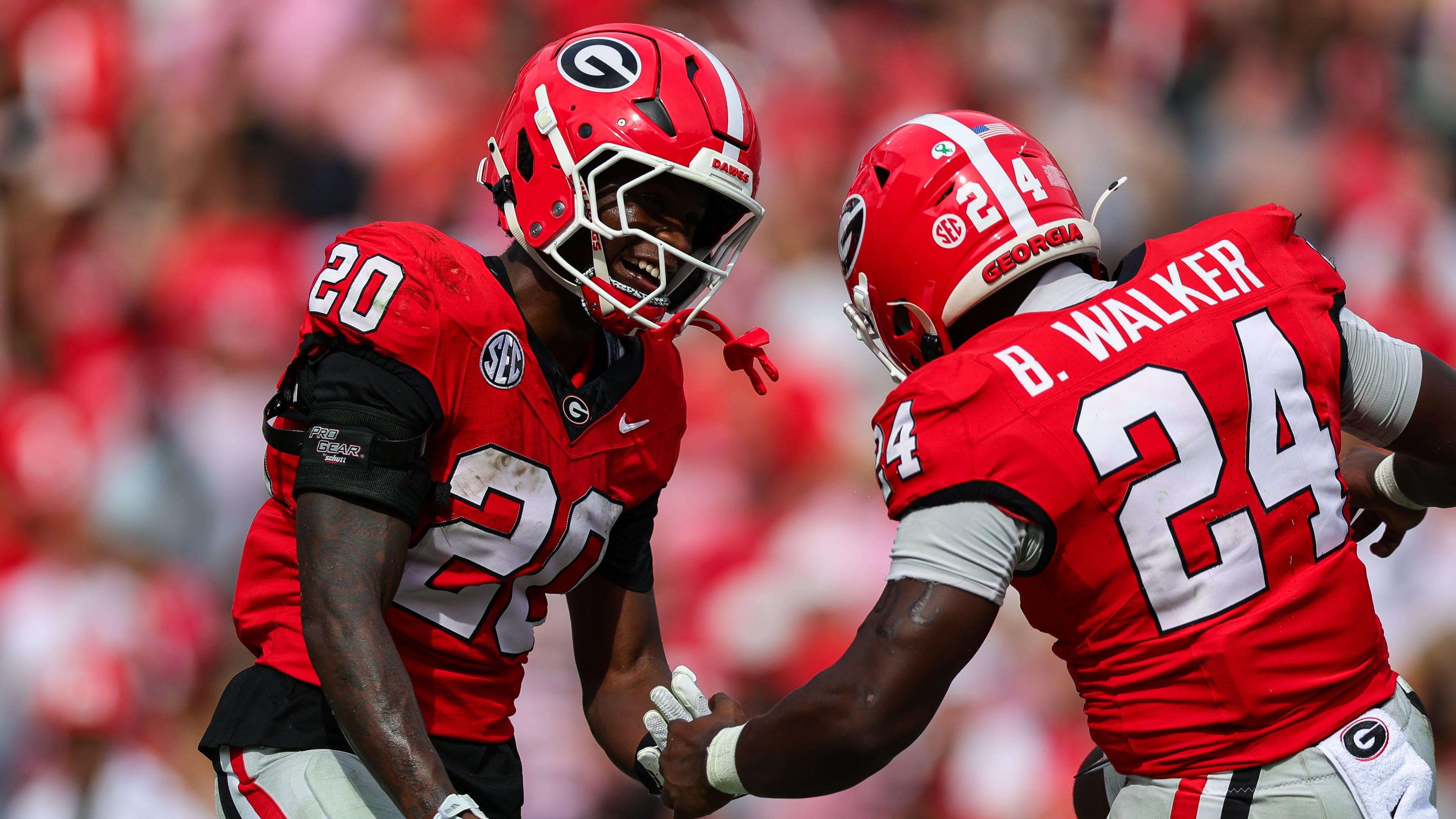 Georgia running back Dwight Phillips Jr. (20) high-fives running back Bo Walker (24) after scoring a touchdown during the second half of an NCAA college football game against Vanderbilt, Saturday, Oct. 3, 2026, in Athens, Ga. (AP Photo/Colin Hubbard)