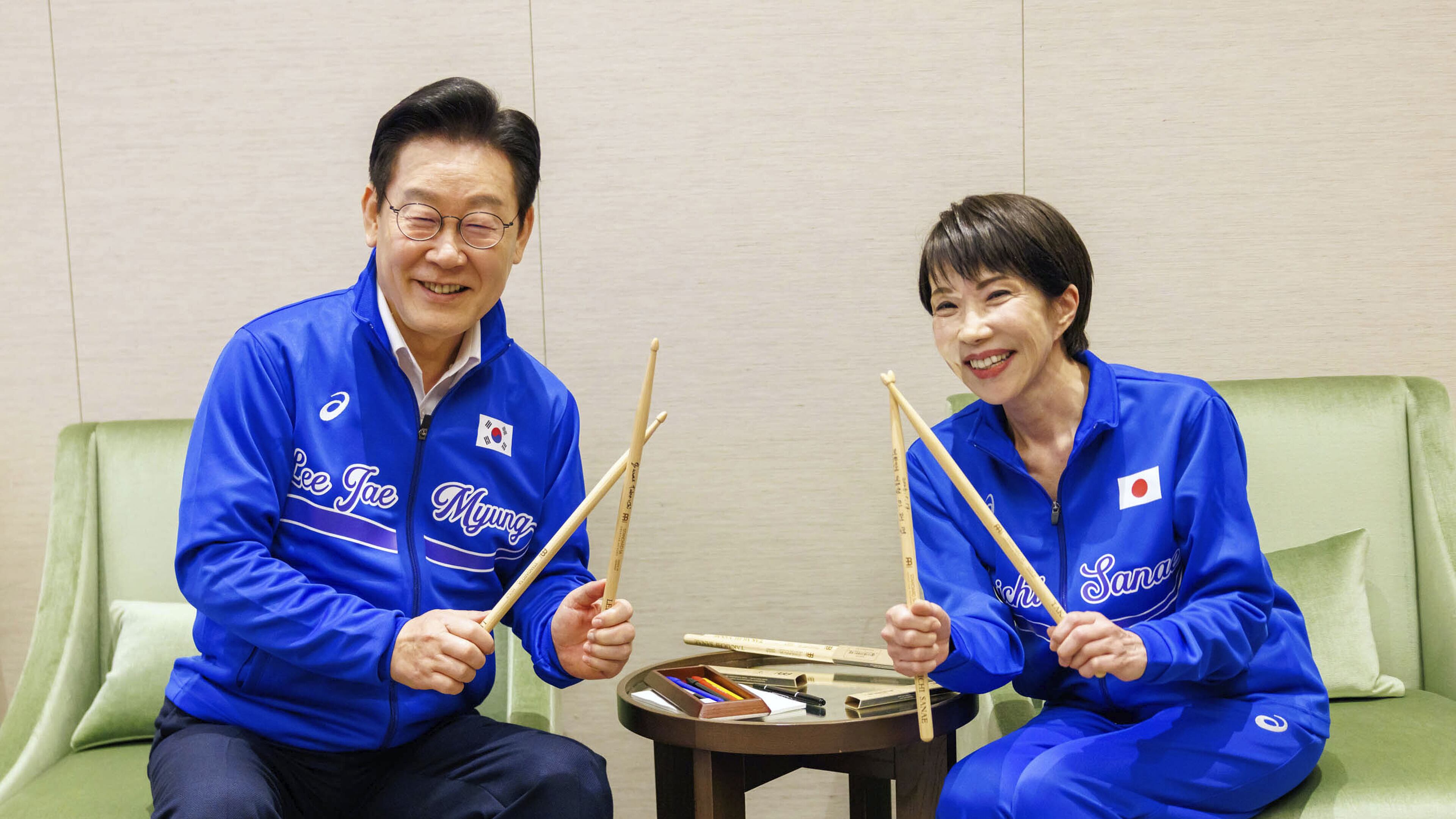 In this photo released on the official website of Prime Minister's Office of Japan, Japanese Prime Minister Sanae Takaichi, right, and South Korean President Lee Jae Myung pose for a photo as they play drump together after their talks in Nara, western Japan Tuesday, Jan. 13, 2026. (Prime Minister's Office of Japan via AP)