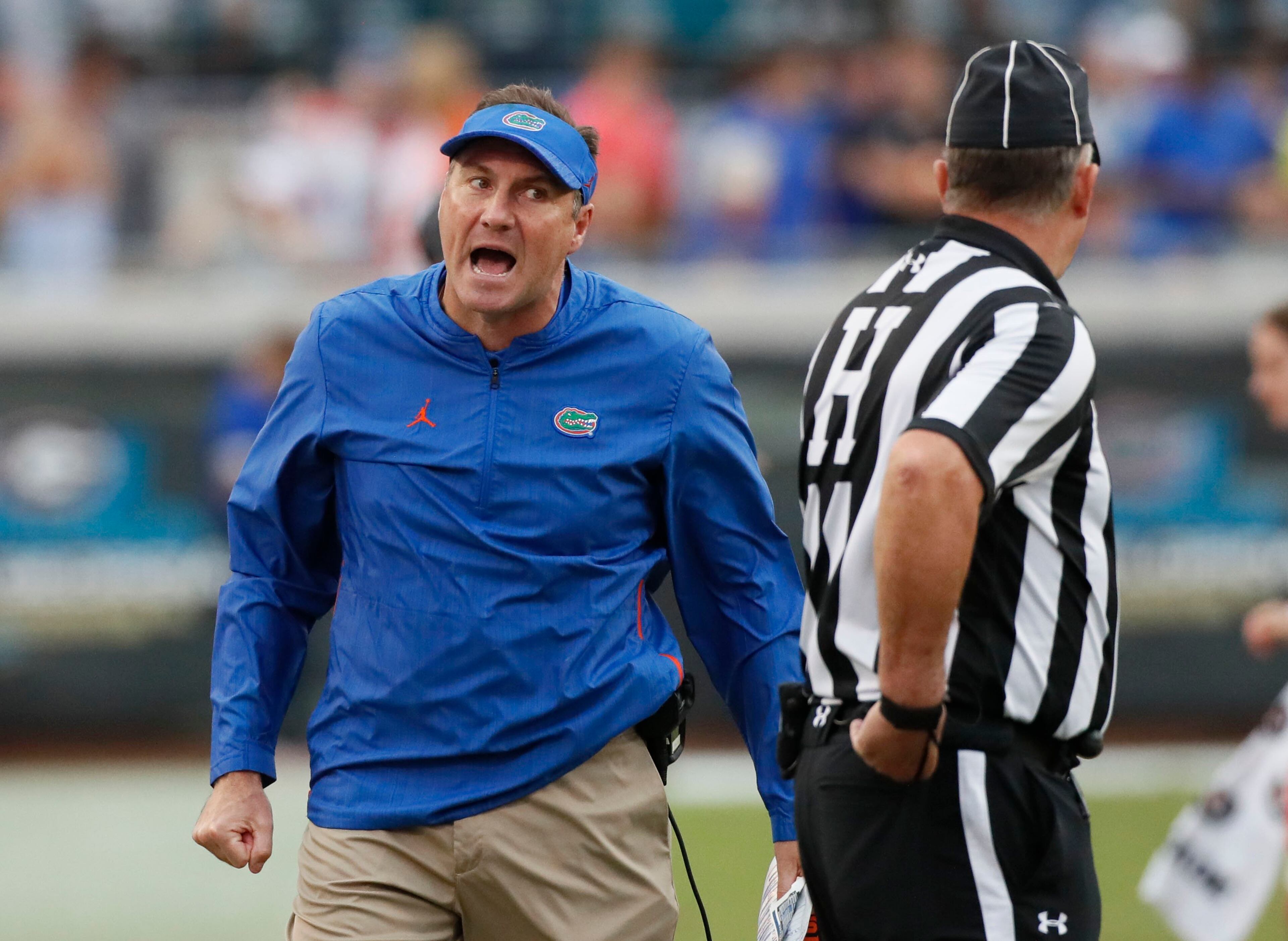 10/27/18 - Jacksonville - Florida coach Dan Mullen has a conversation with the officials after he was penalized for unsportsmanlike conduct in the second half. The University of Georgia Bulldogs beat the Florida Gators 36-17 in a NCAA college football game Saturday, Oct. 27th, 2018, at TIAA Bank Field in Jacksonville, FL. BOB ANDRES / BANDRES@AJC.COM