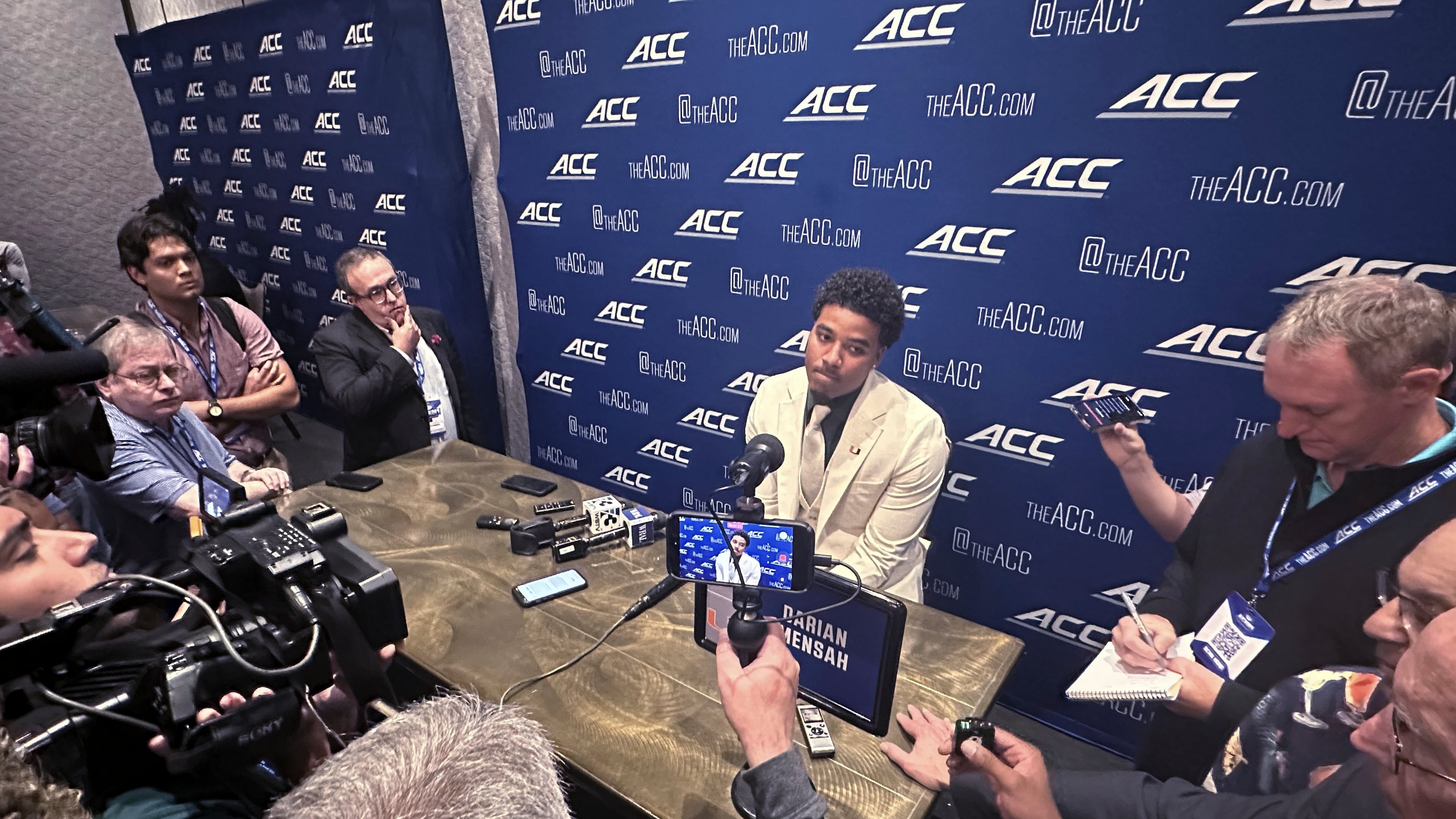 Miami quarterback Darian Mensah listens during ACC Kickoff preseason football media days, Wednesday, July 15, 2026 in Charlotte, N.C. (AP Photo/Aaron Beard)