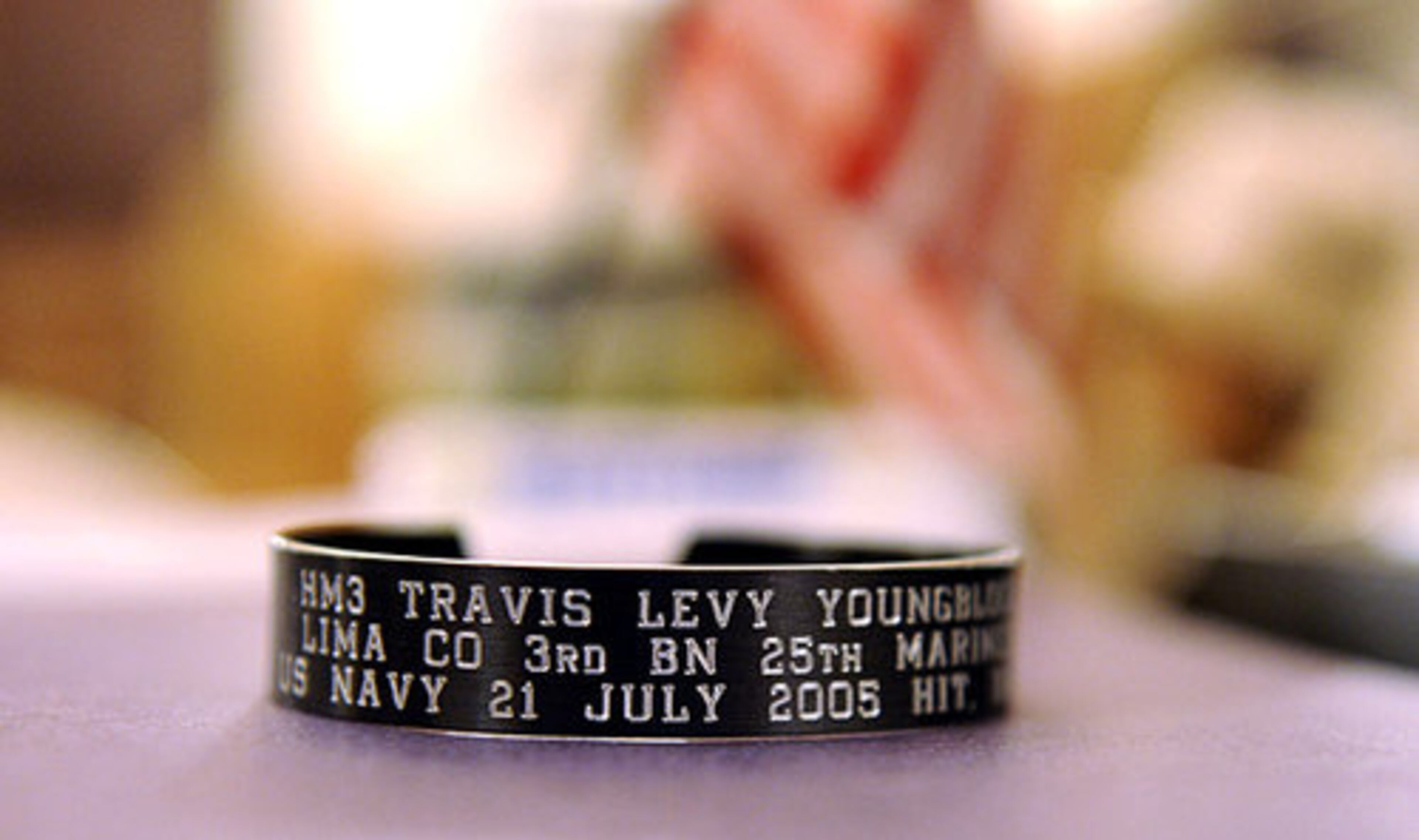 The bracelet of a soldier who died in Iraq sits on McCain's desk.