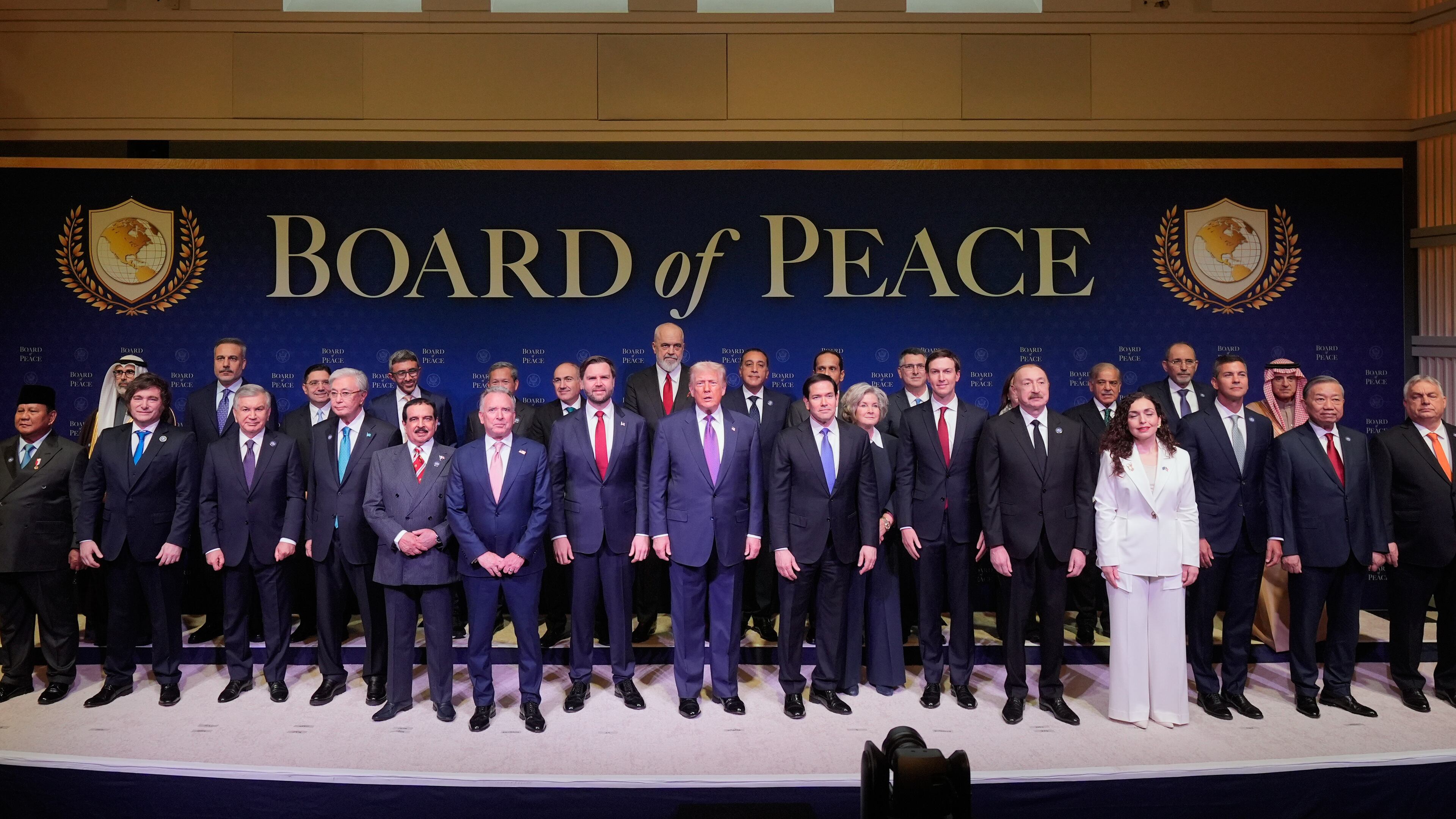 President Donald Trump stands with other World leaders before a Board of Peace meeting at the U.S. Institute of Peace, Thursday, Feb. 19, 2026, in Washington. (AP Photo/Mark Schiefelbein)