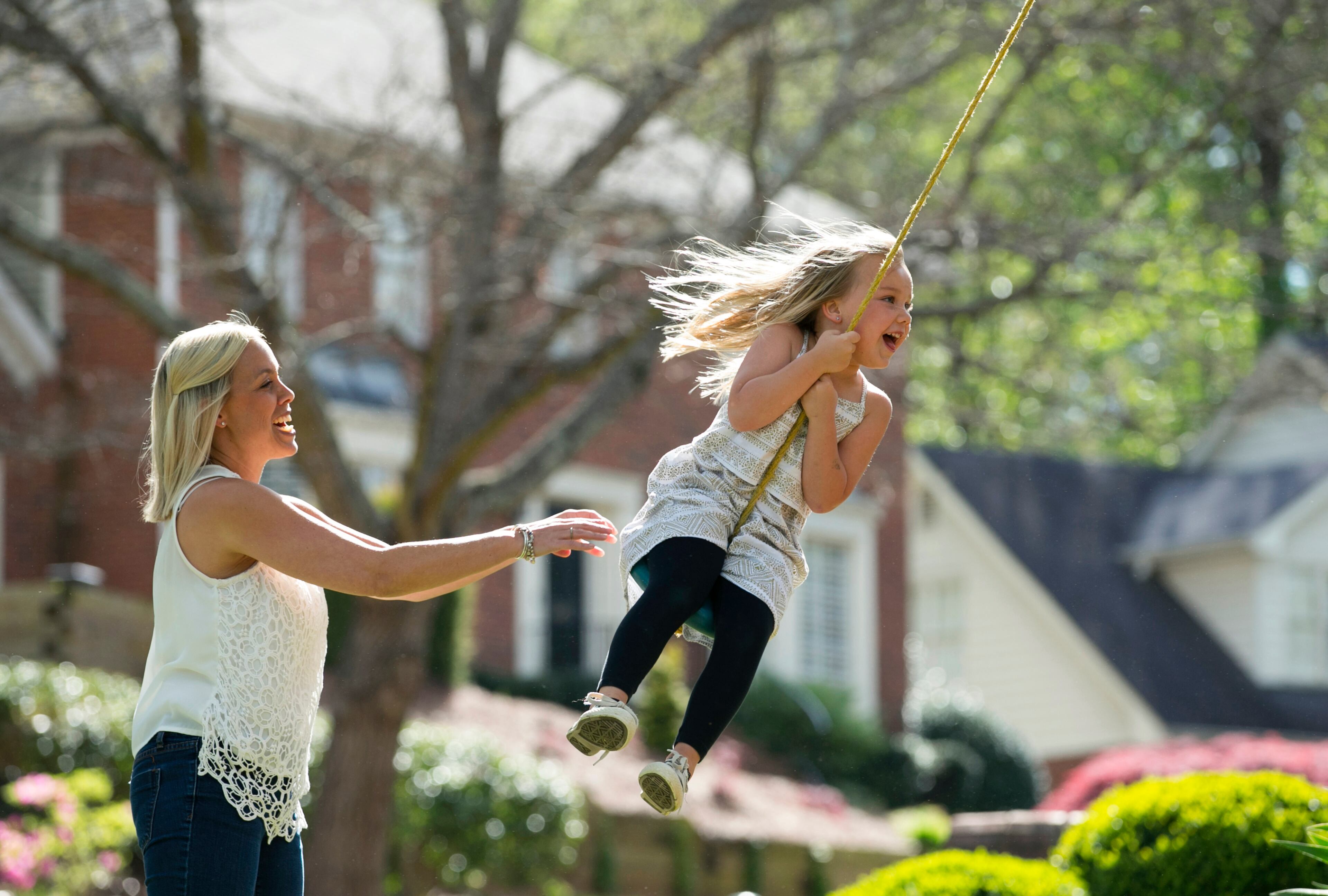 April 8, 2016 - Johns Creek, Ga: Elizabeth Warren pushes her daughter Kingsley, 5 on their swing in front of their home in the Mayfair subdivision Friday, April 8, 2016, in Johns Creek, Ga. This is for the insider's guide feature about the Newtown neighborhood. PHOTO / JASON GETZ
