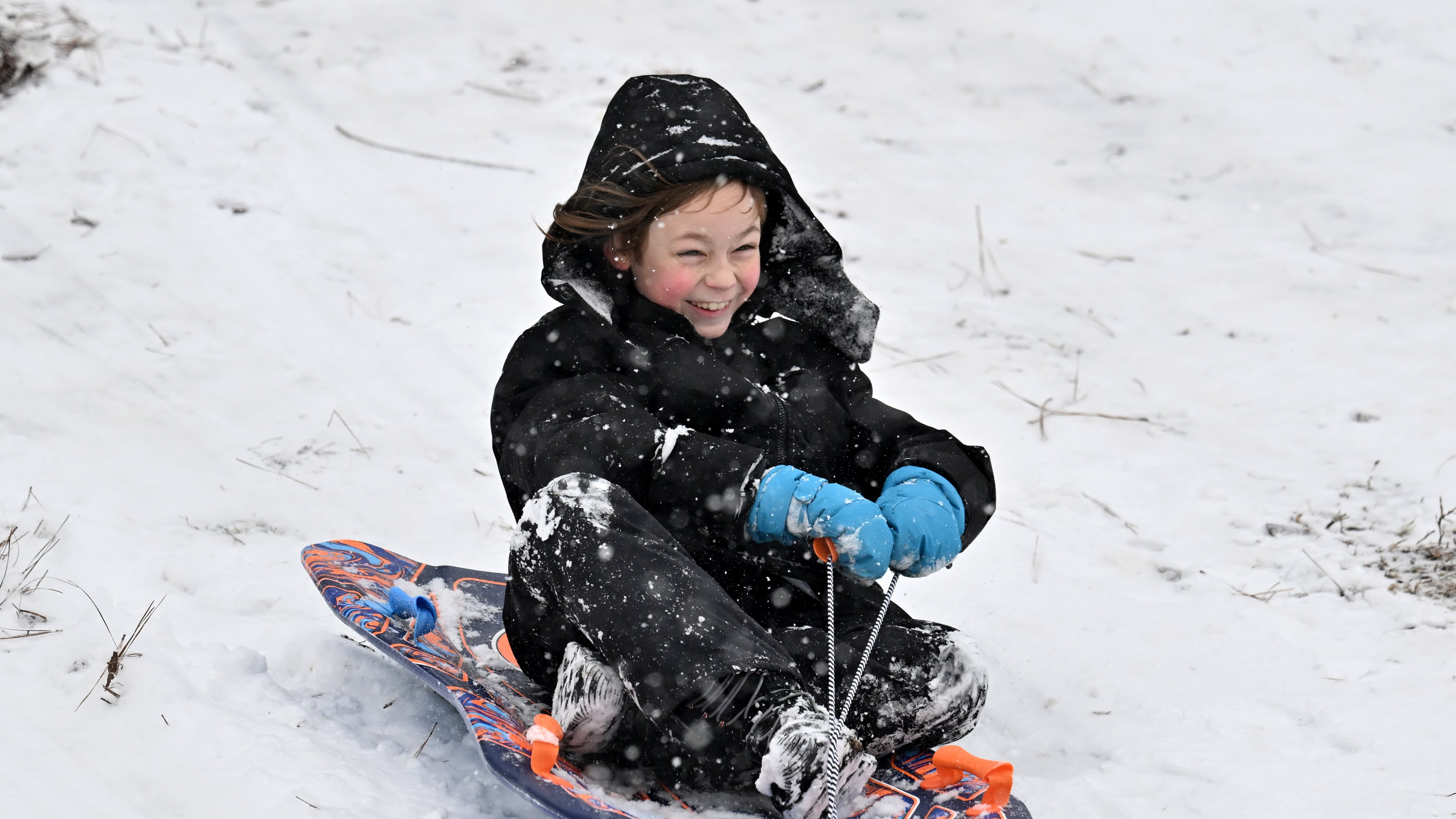 Benny Myers, 9, sleds down a hill at Little Mulberry Park in Dacula on Saturday. Although Gen. Beauregard Lee saw predicted six more weeks of winter, it won't be as cold and snowy as the past couple of weeks. (Hyosub Shin/AJC)