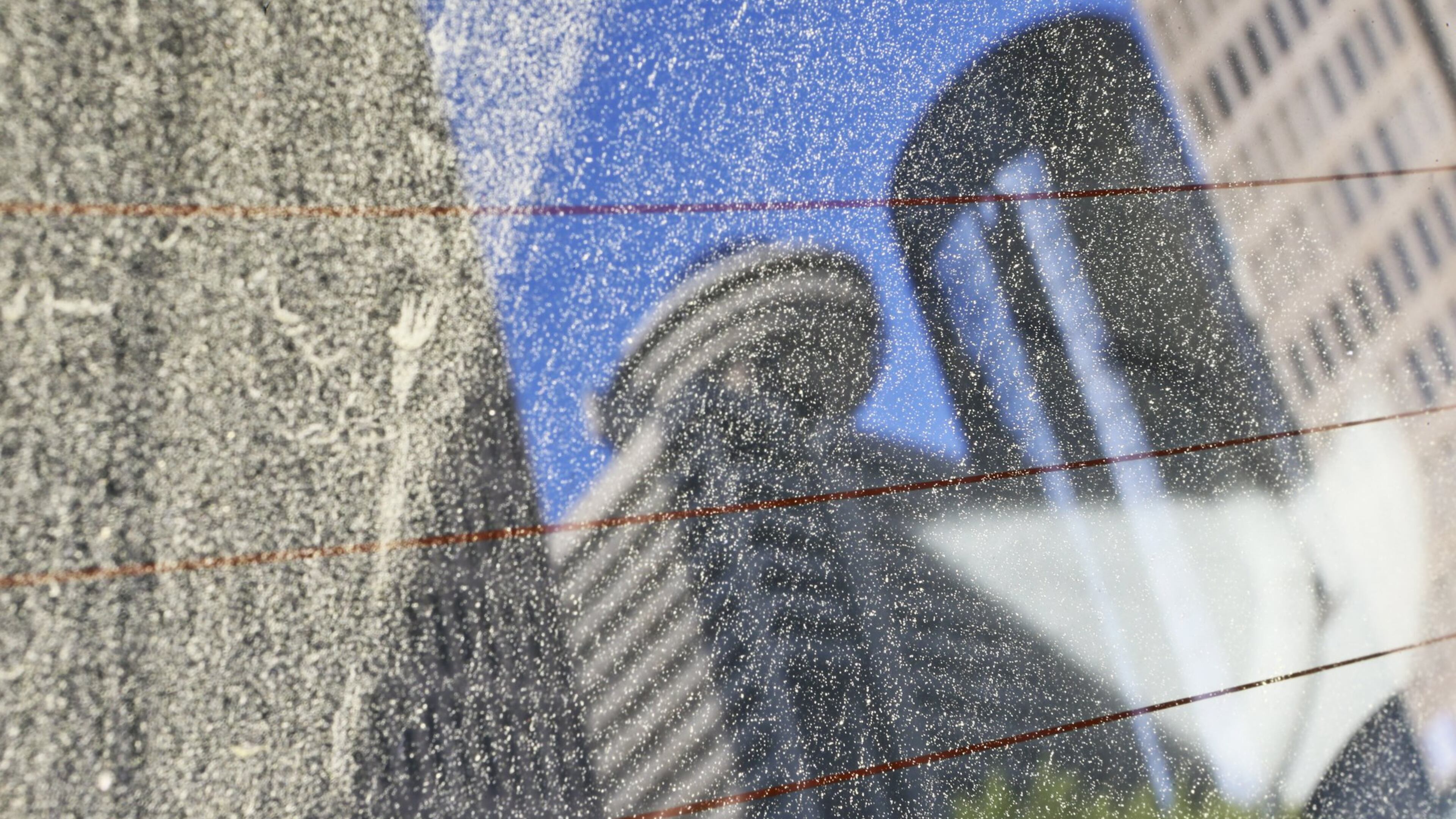 A parked car at John Portman Blvd. and Peachtree Center Avenue reflects a pollinated view of the Atlanta skyline from the back window in April 2013. JOHN SPINK / JSPINK@AJC.COM