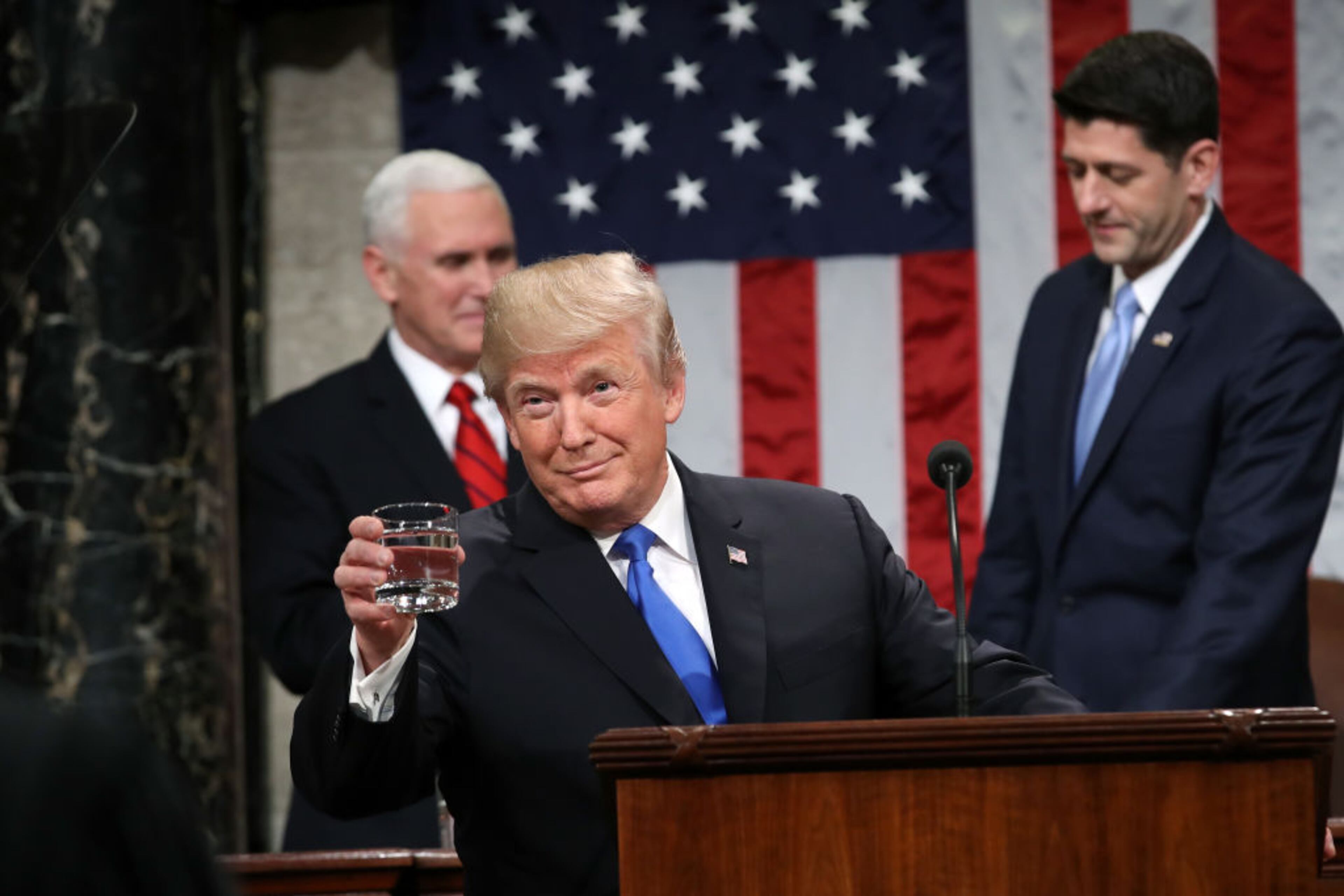 WASHINGTON, DC - JANUARY 30: U.S. President Donald J. Trump holds a glass of water before he delivers the State of the Union address as U.S. Vice President Mike Pence (L) and Speaker of the House U.S. Rep. Paul Ryan (R-WI) (R) look on in the chamber of the U.S. House of Representatives January 30, 2018 in Washington, DC. This is the first State of the Union address given by U.S. President Donald Trump and his second joint-session address to Congress. (Photo by Win McNamee/Getty Images)