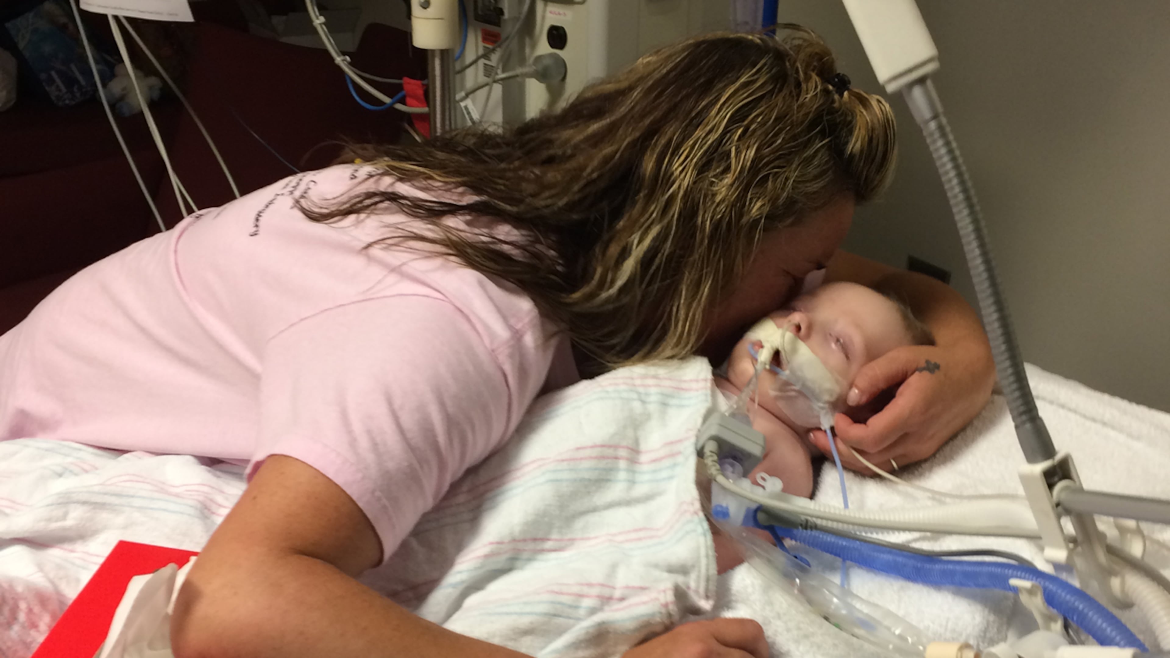Dinah Paige Whited receives a kiss from her maternal grandmother, Paige Cason-Barrett, Wednesday night at Children's Healthcare of Atlanta at Egleston. The Atlanta Journal-Constitution was in Dinah's room with the permission of Paige Cason-Barrett. Craig Schneider / cschneider@ajc.com