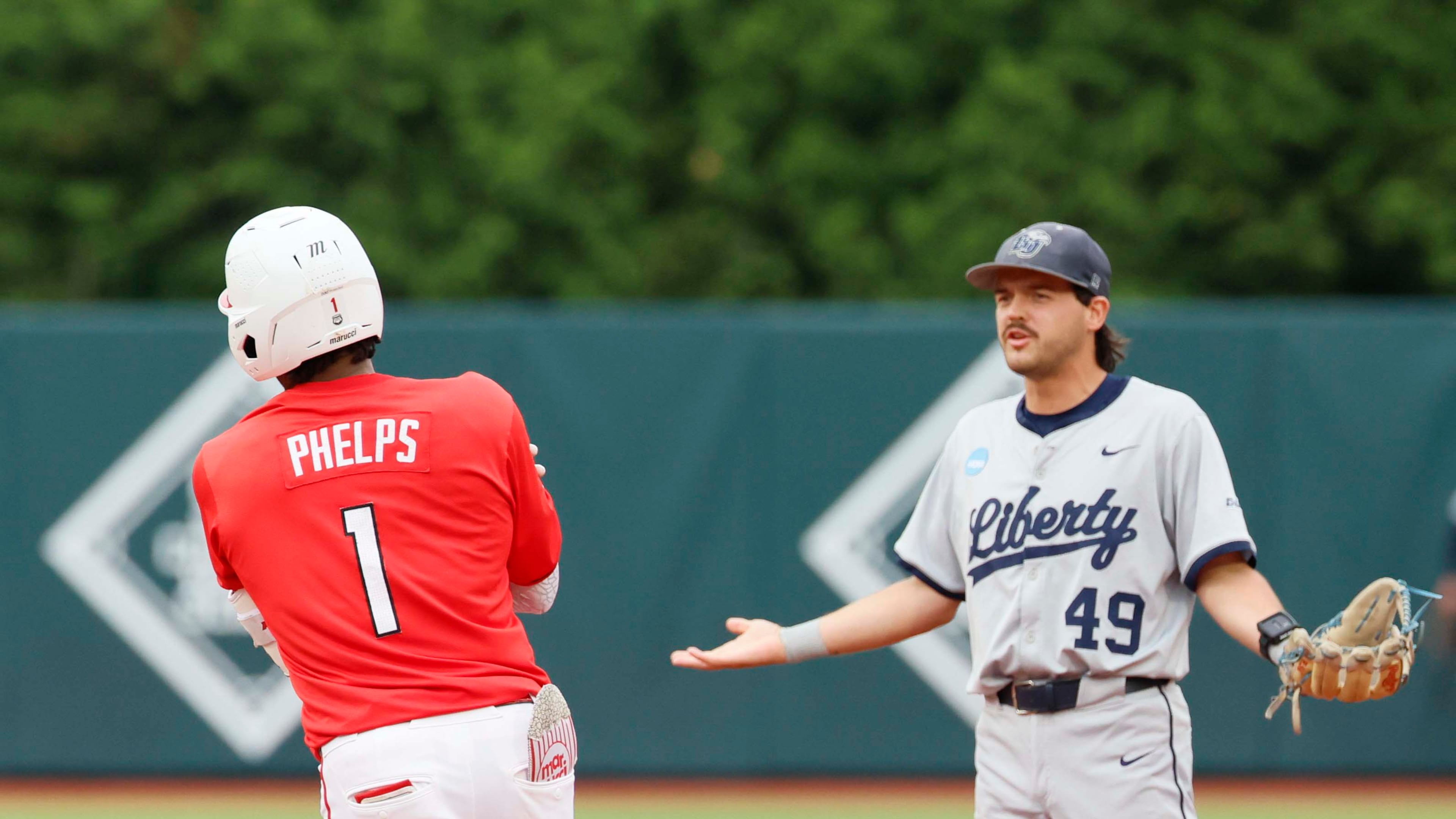 Liberty Flames infielder Easton Swofford (49) argues with Georgia Bulldogs infielder Tre Phelps (1) as he runds the bases after hitting a two-run home run during the sixth inning of their NCAA Regional final game at Foley Field on Sunday, May 31, 2026, in Athens. Tre Phelps was later ejected for excessive celebration. (Miguel Martinez/AJC)